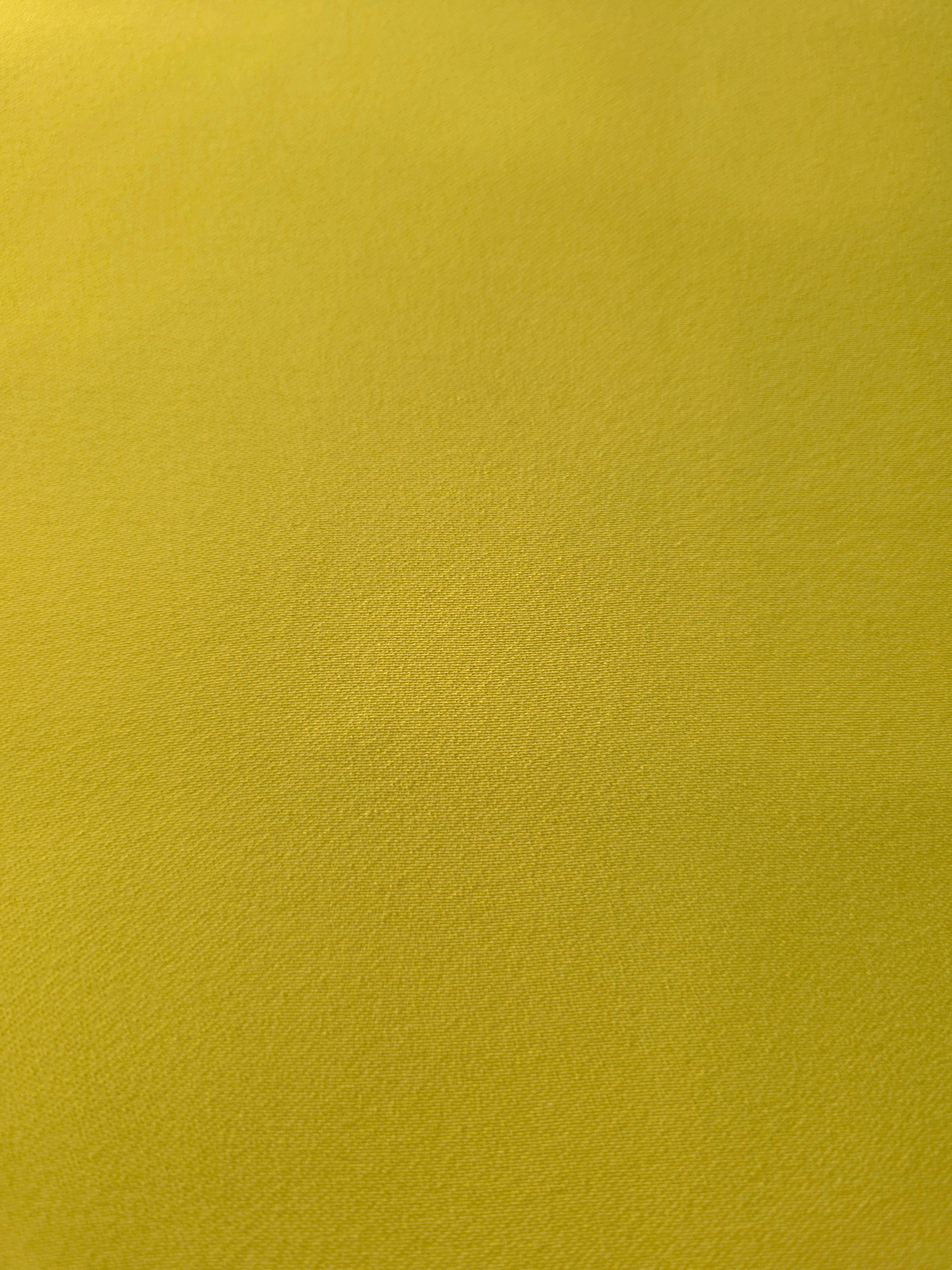 Close-up of Olive Gold mechanical polyester crepe showing fine woven texture and a smooth silky-soft hand