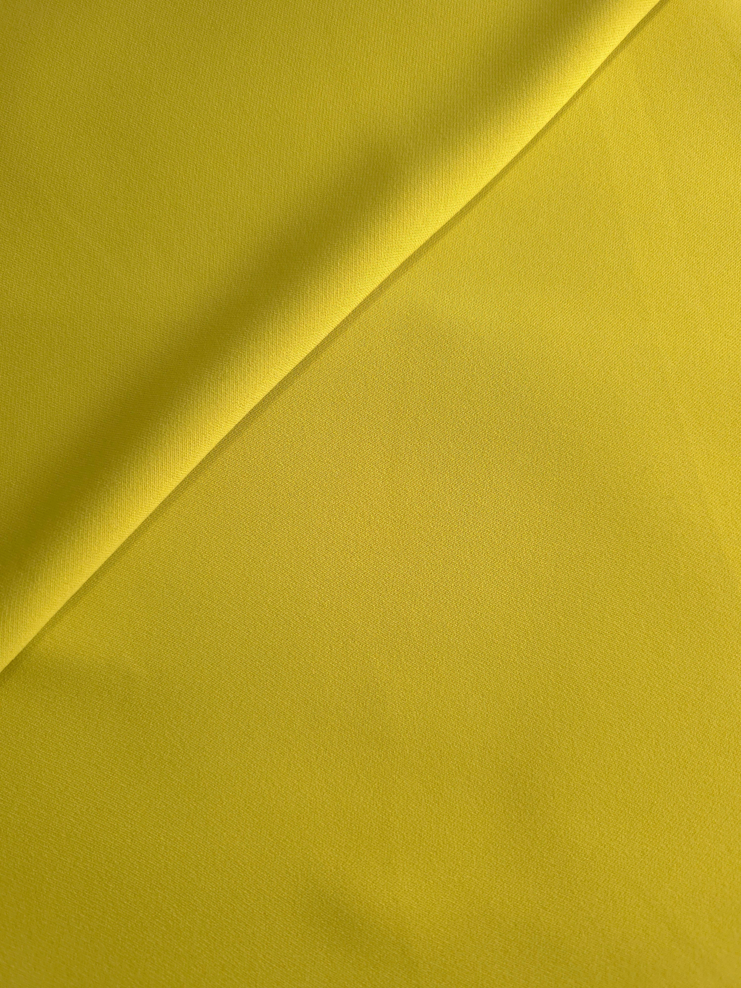 Olive Gold Italian crepe in a soft fold, showing fluid drape for blouses, dresses and flowing skirts