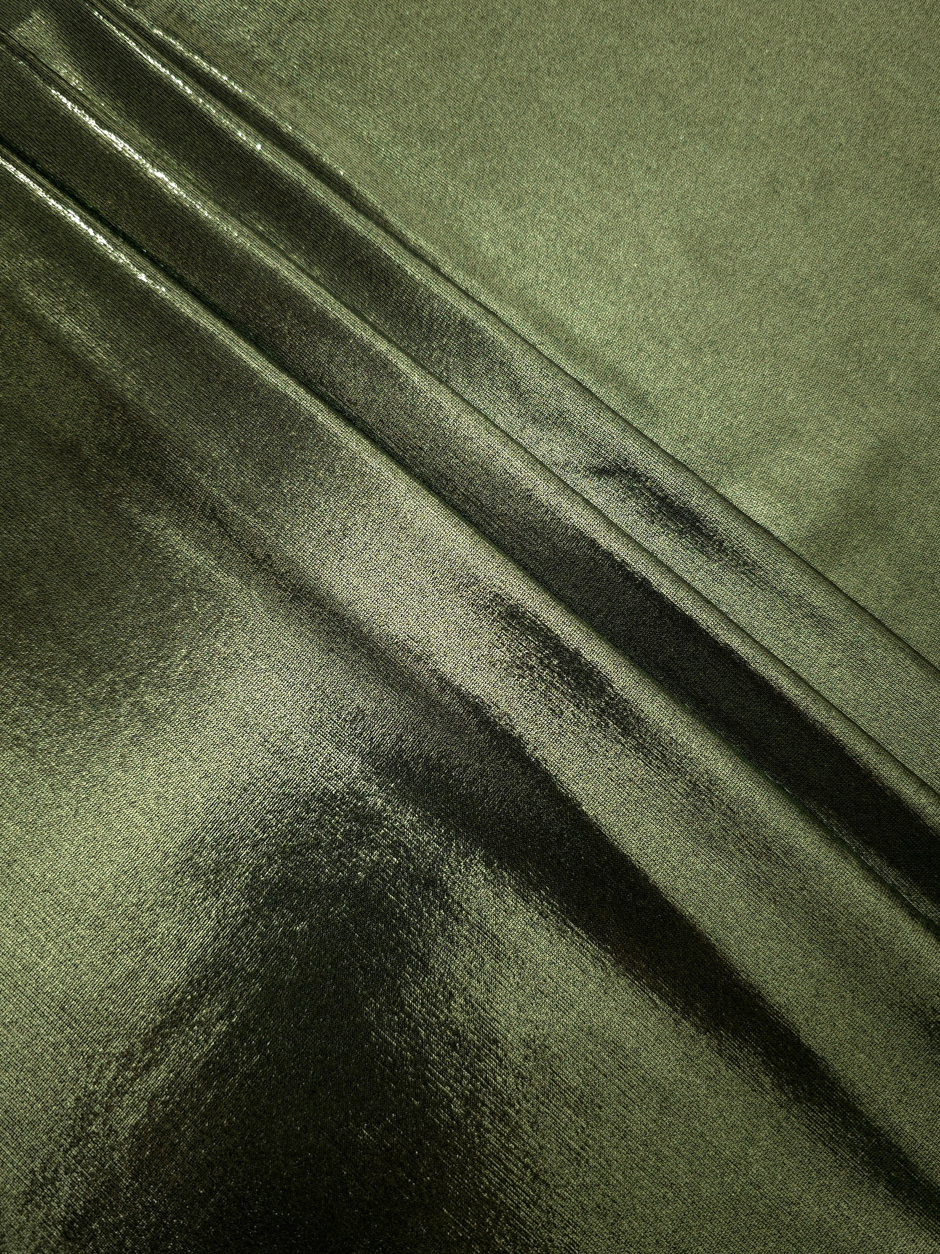 Olive Green shimmer spandex fabric stacked in soft layers, revealing metallic reflection for costumes, dresses and creative apparel