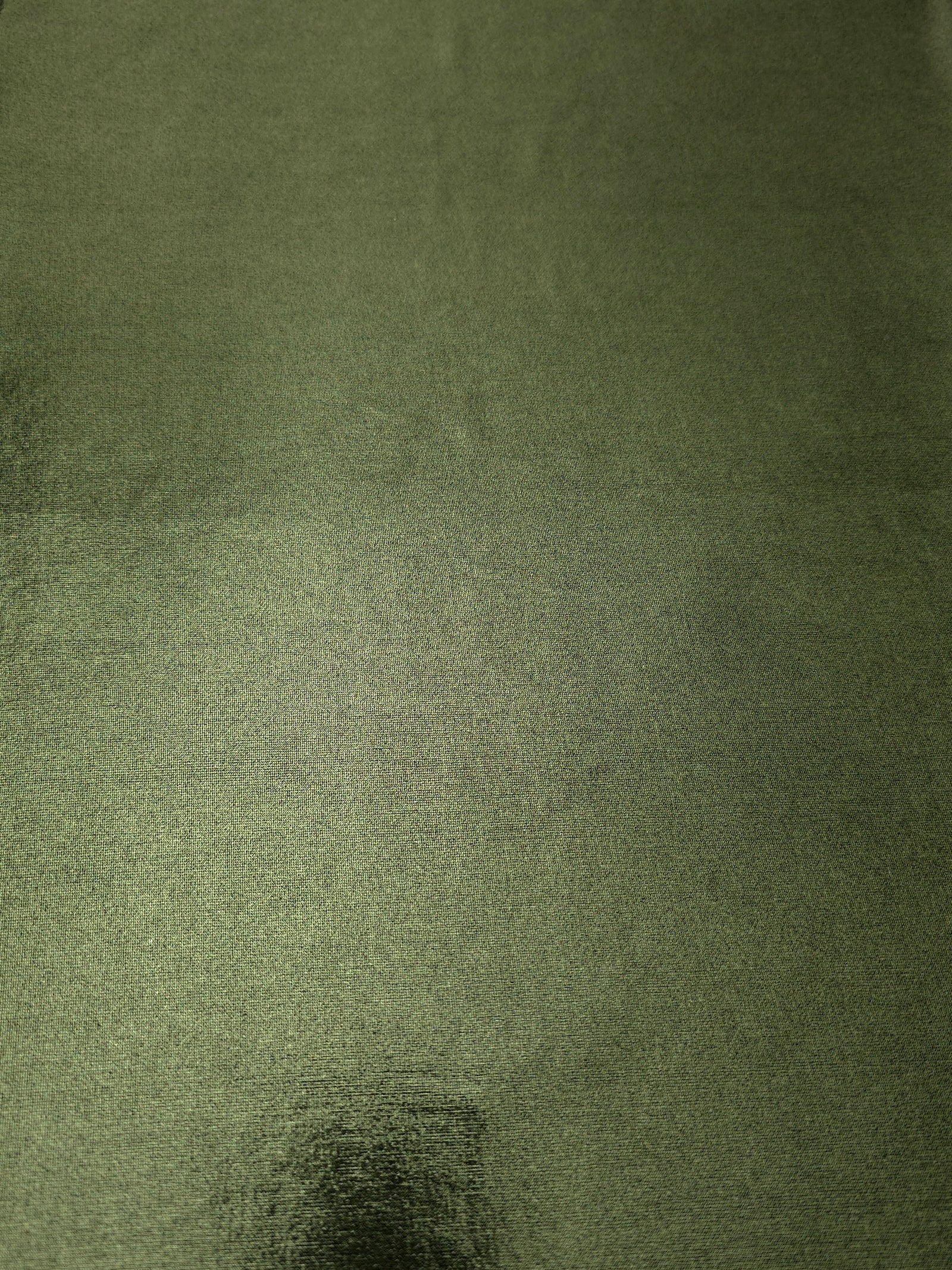 Full surface of Olive Green metallic stretch fabric, highlighting luminous foil sheen for stage costumes, dresses and fashion design