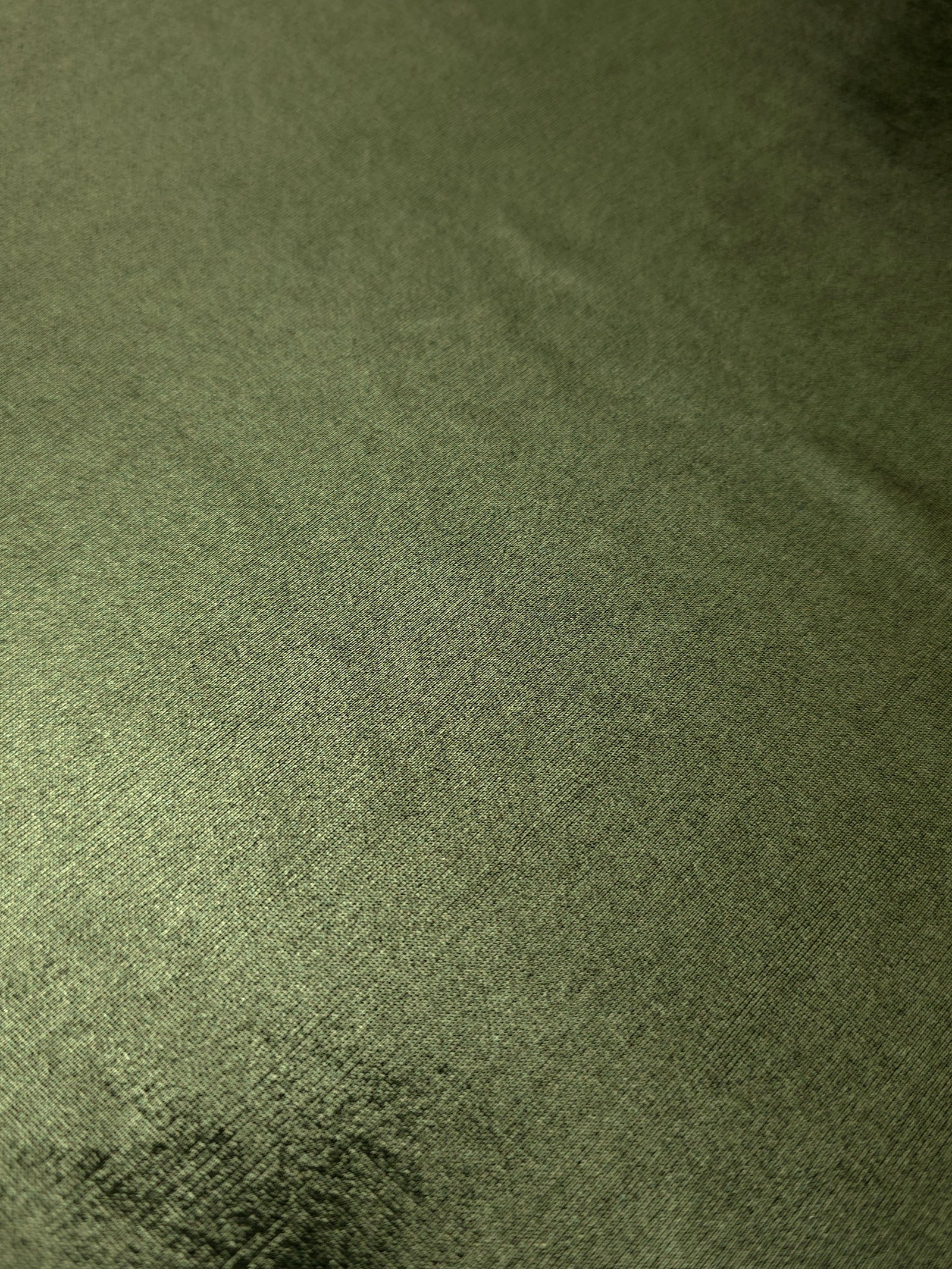 Texture view of Olive Green metallic stretch fabric, highlighting foil shimmer and surface detail for performance apparel