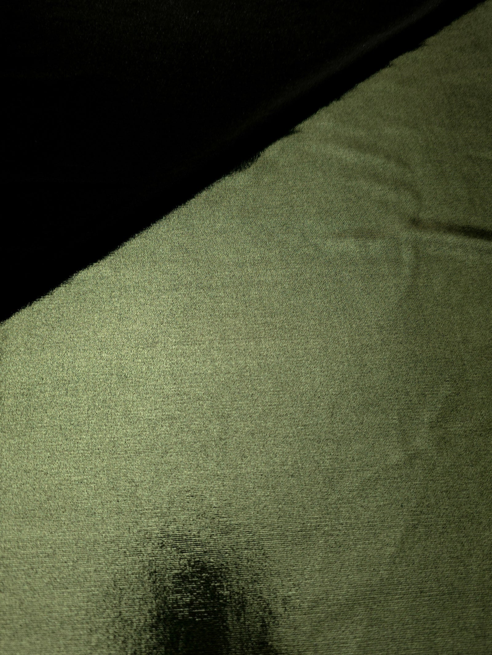 Gently folded Olive Green shimmer spandex fabric showing luminous foil finish for tops, skirts and occasion garments