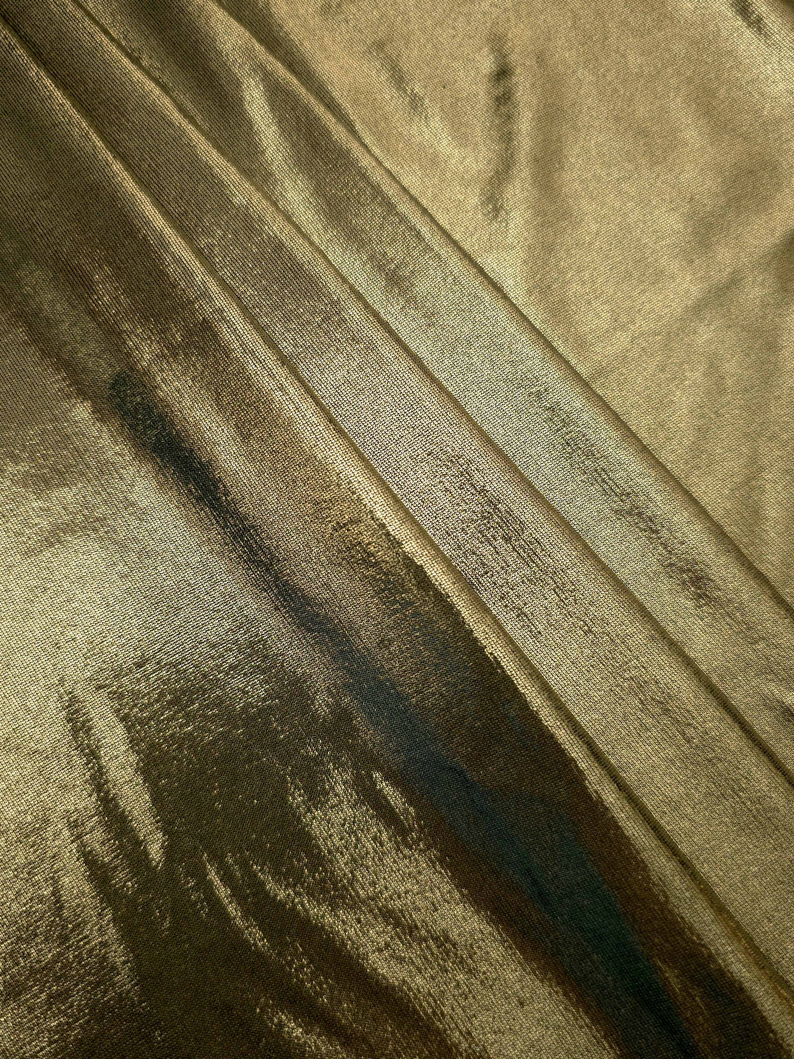 Olive Khaki shimmer spandex fabric stacked in soft layers, revealing metallic reflection for costumes, dresses and creative apparel