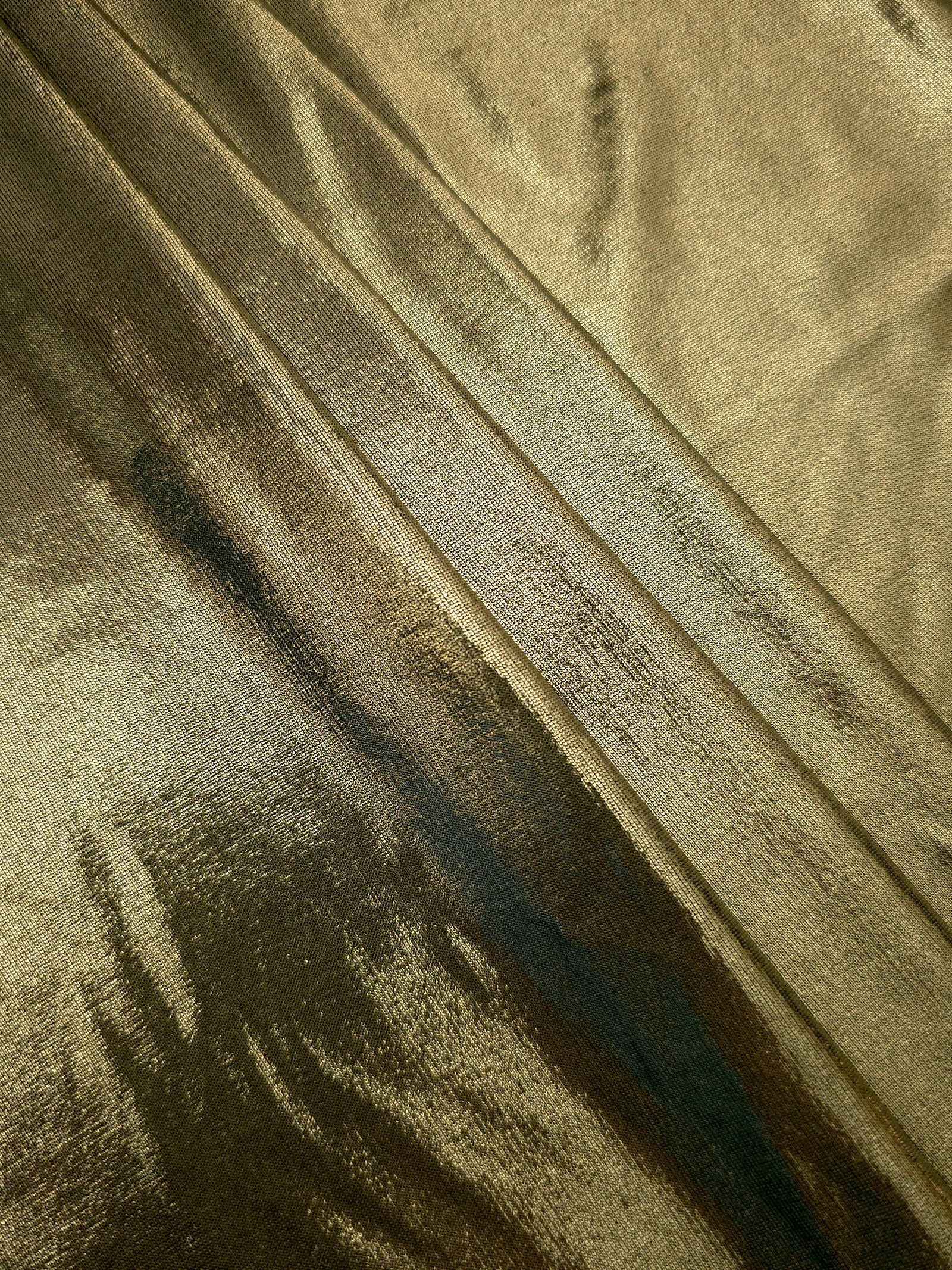 Olive Khaki shimmer spandex fabric stacked in soft layers, revealing metallic reflection for costumes, dresses and creative apparel
