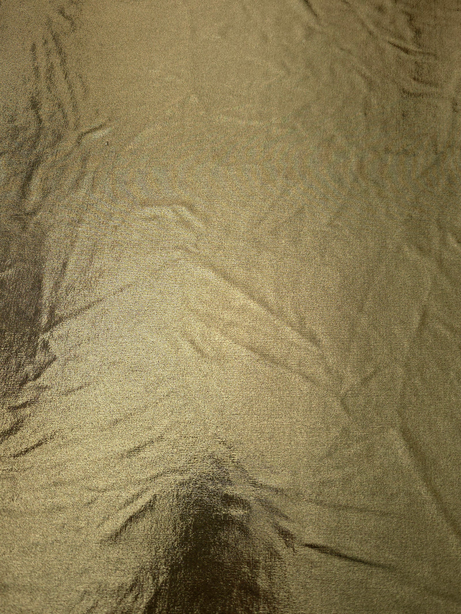 Full surface of Olive Khaki metallic stretch fabric, highlighting luminous foil sheen for stage costumes, dresses and fashion design