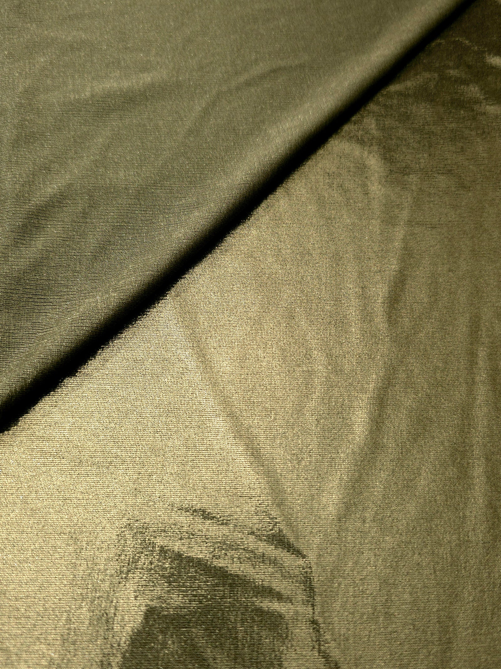 Gently folded Olive Khaki shimmer spandex fabric showing luminous foil finish for tops, skirts and occasion garments