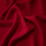 Oxblood Red polyester crepe in long draped folds, showing flowing coverage for abayas and modest fashion