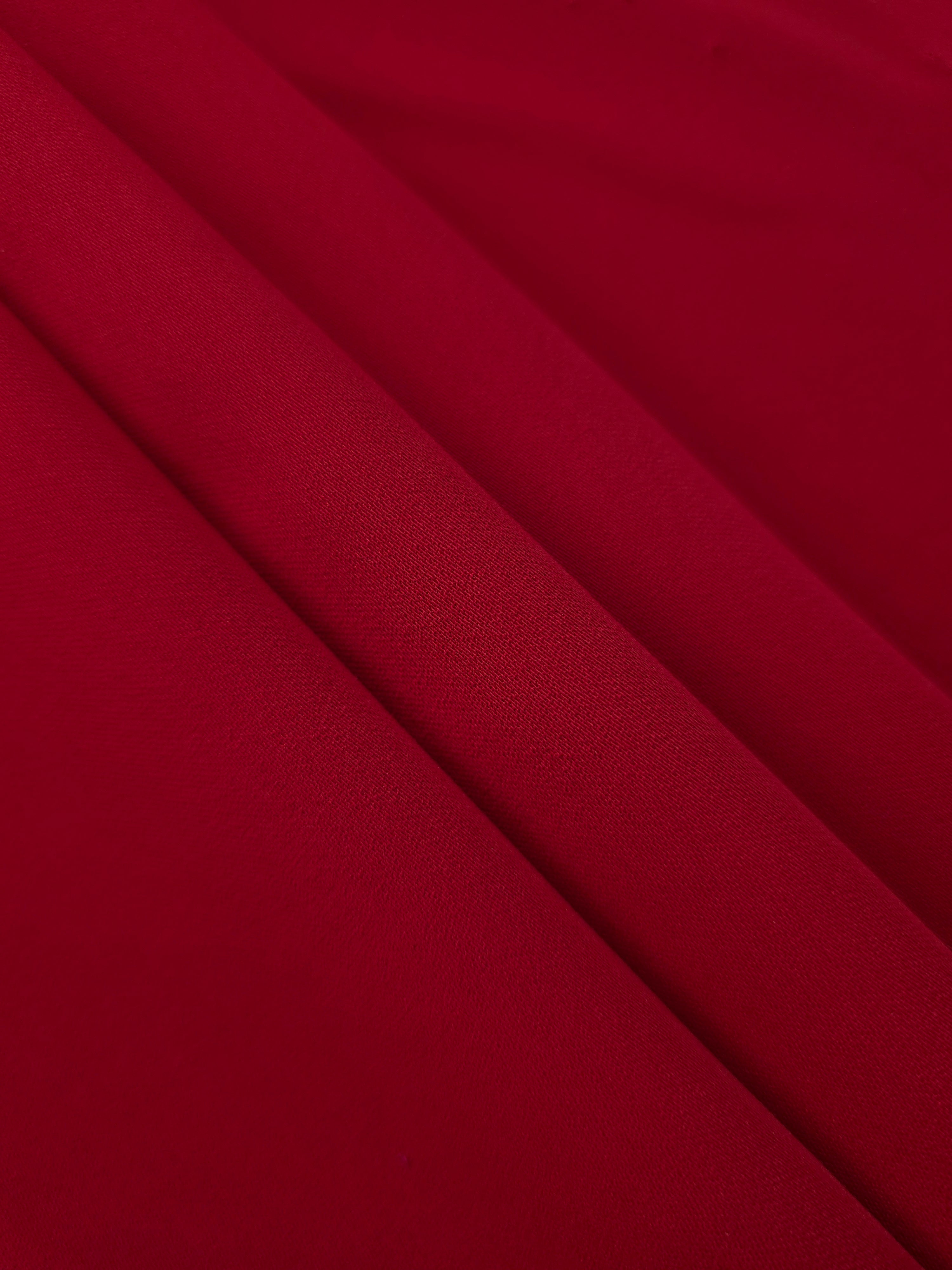 Oxblood Red Korean crepe in layered folds, showing soft structure and slight mechanical stretch for skirts