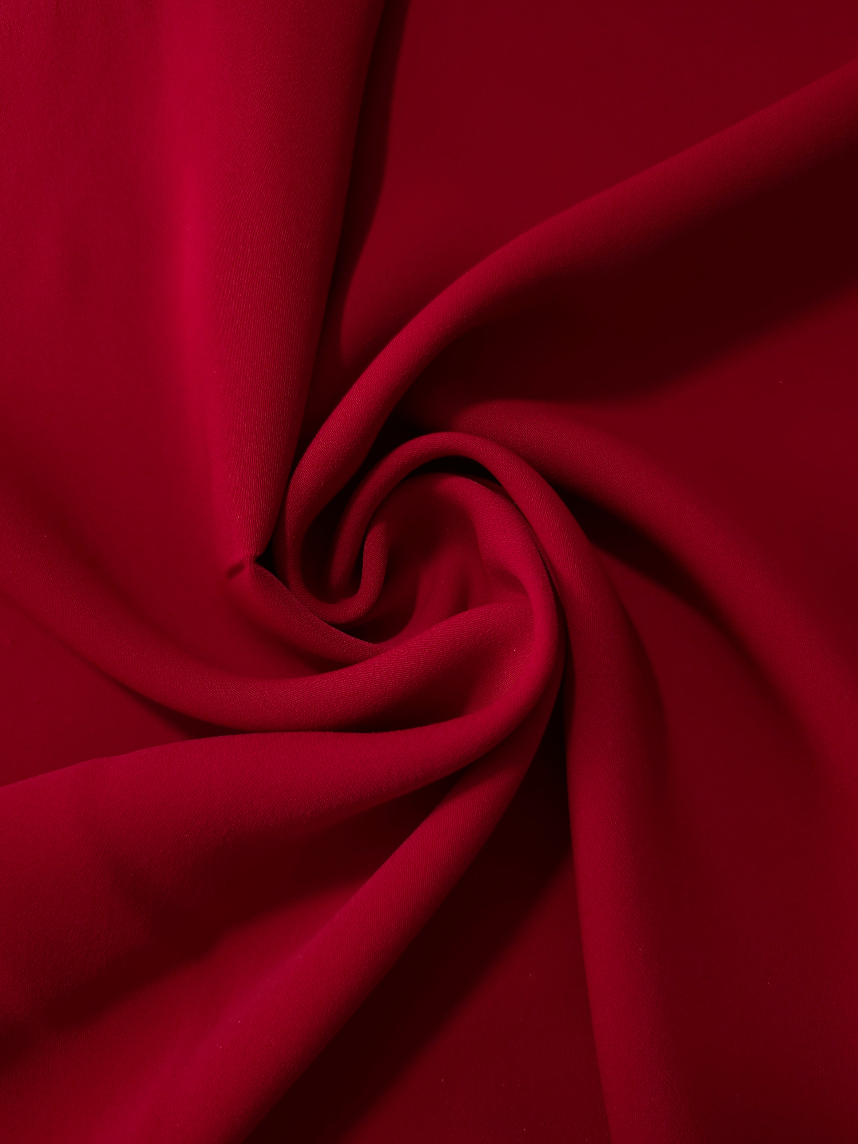 Swirled Oxblood Red Korean crepe showing fluid movement and silky drape for dresses and occasionwear