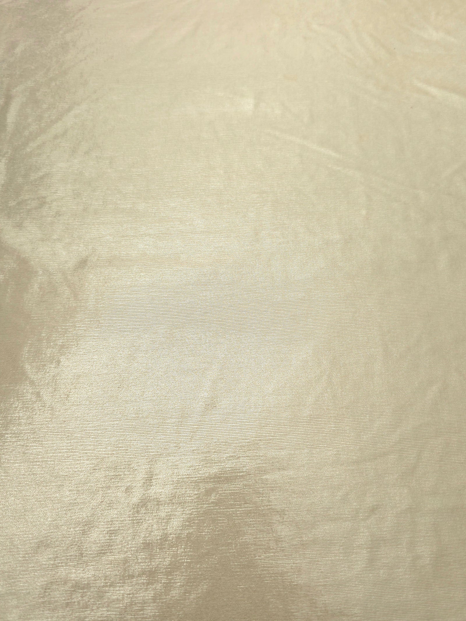 Pale Butter Cream foiled spandex fabric surface showing even metallic shimmer and stretch-fabric finish for performance and occasionwear