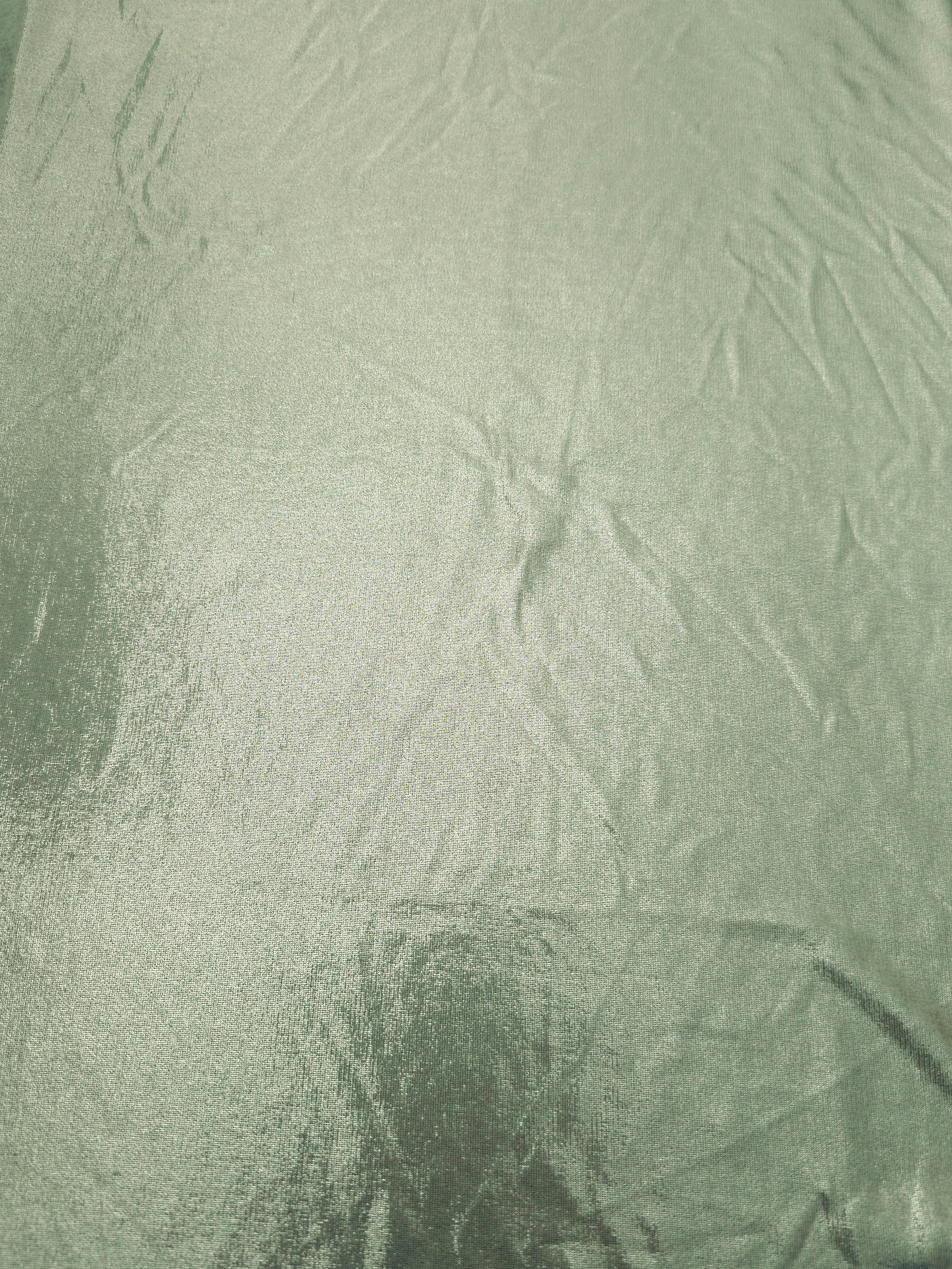Pale Sage Green shimmer metallic foiled spandex shown flat, displaying reflective finish for dance costumes, skirts and event apparel