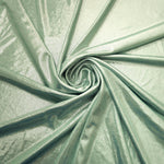 Pale Sage Green foiled spandex styled in a swirl, revealing metallic shine and flexible drape for dance costumes and occasion looks