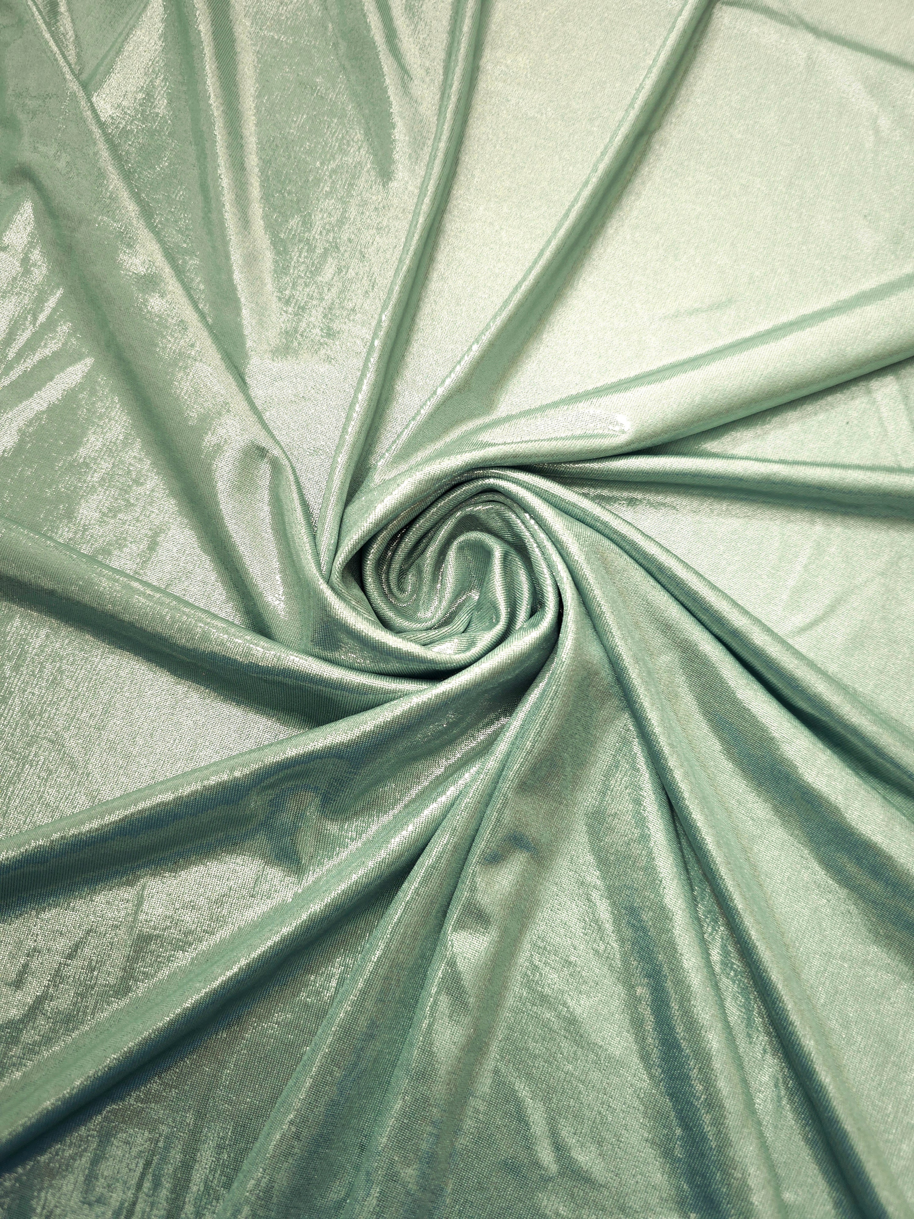 Pale Sage Green foiled spandex styled in a swirl, revealing metallic shine and flexible drape for dance costumes and occasion looks