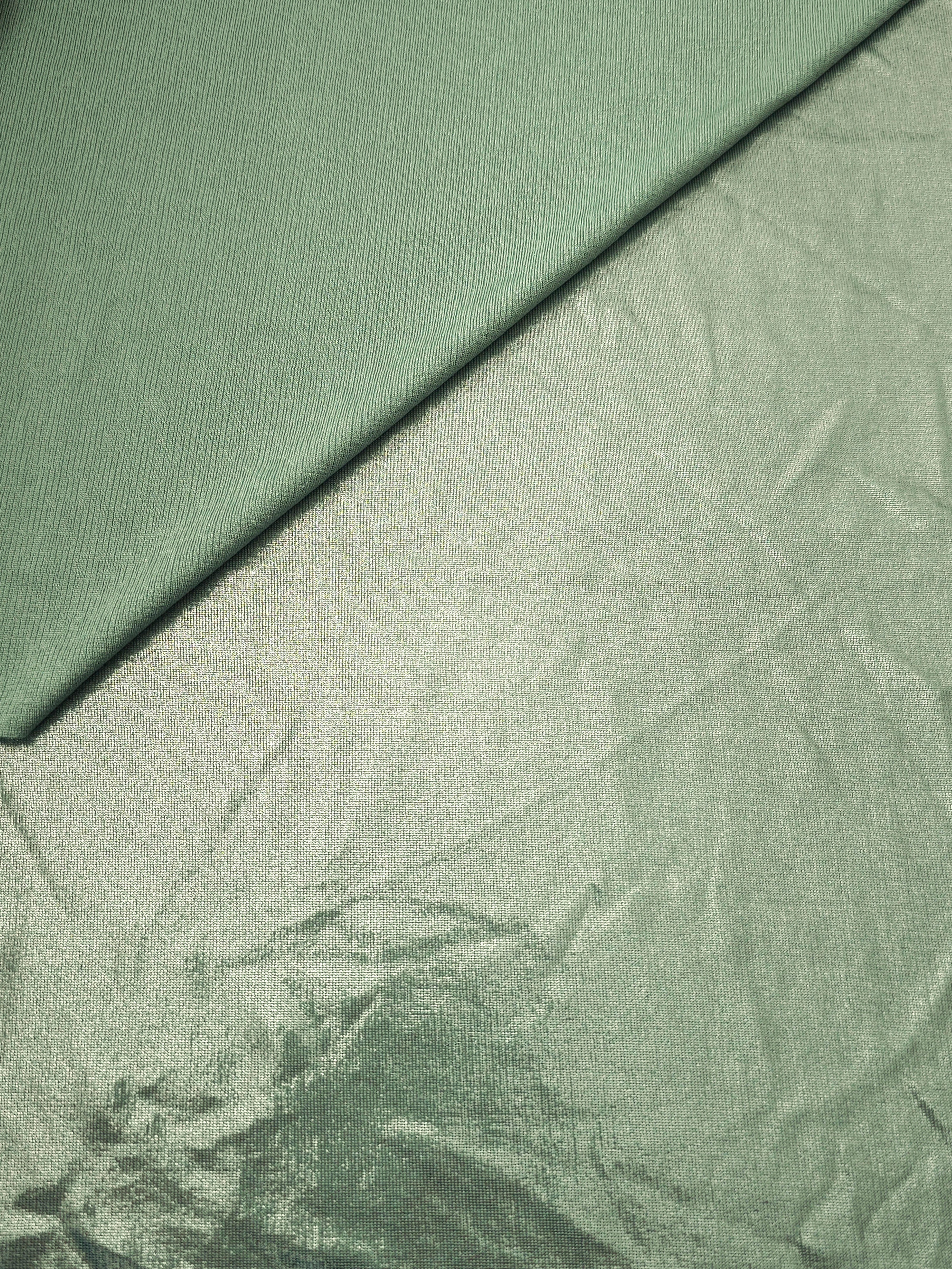Pale Sage Green metallic stretch fabric in a soft fold, revealing reflective drape for dancewear, dresses and statement apparel