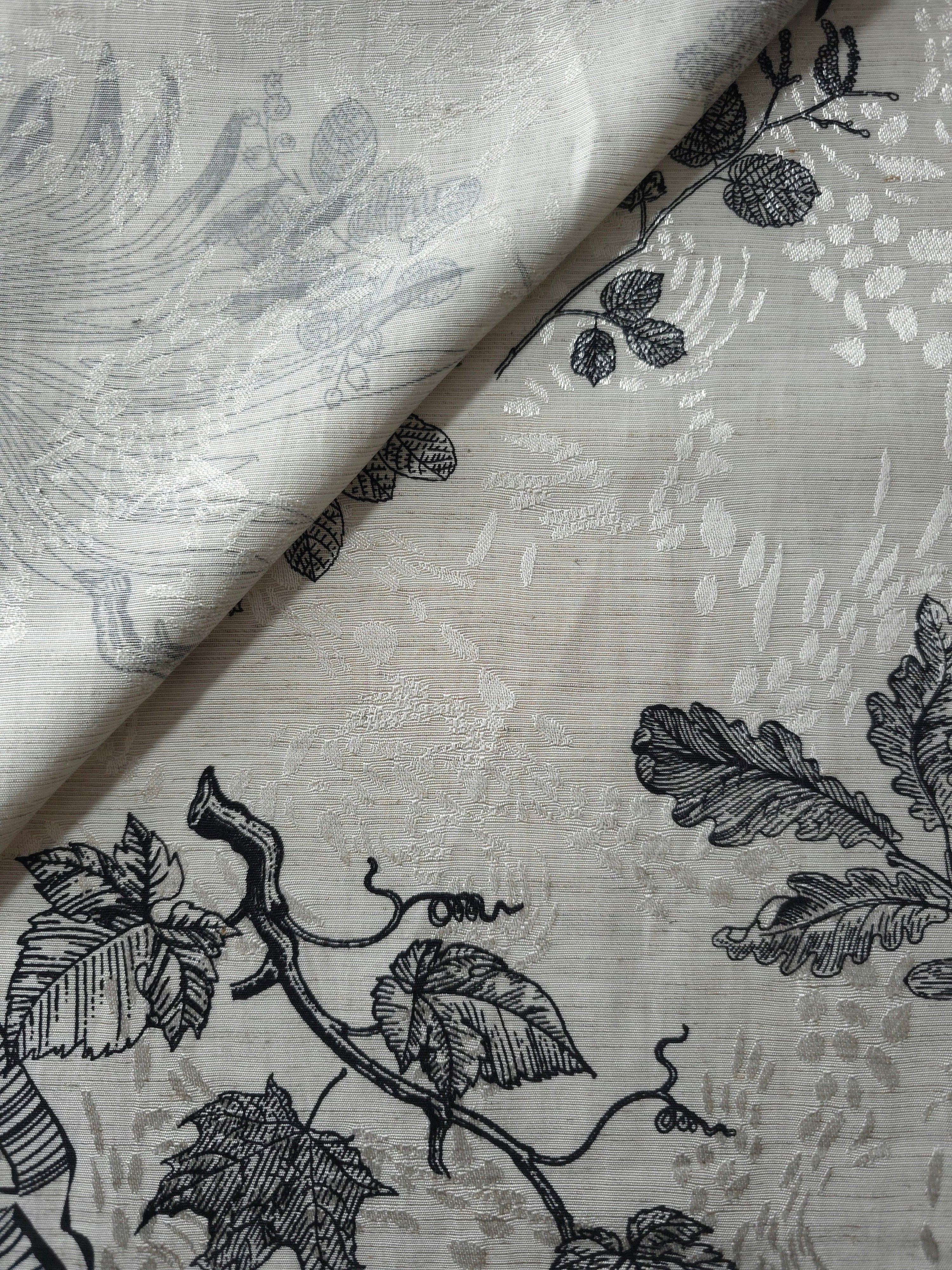 Black palm vine jacquard fabric close-up detail with woven leaf pattern and linen-look texture.