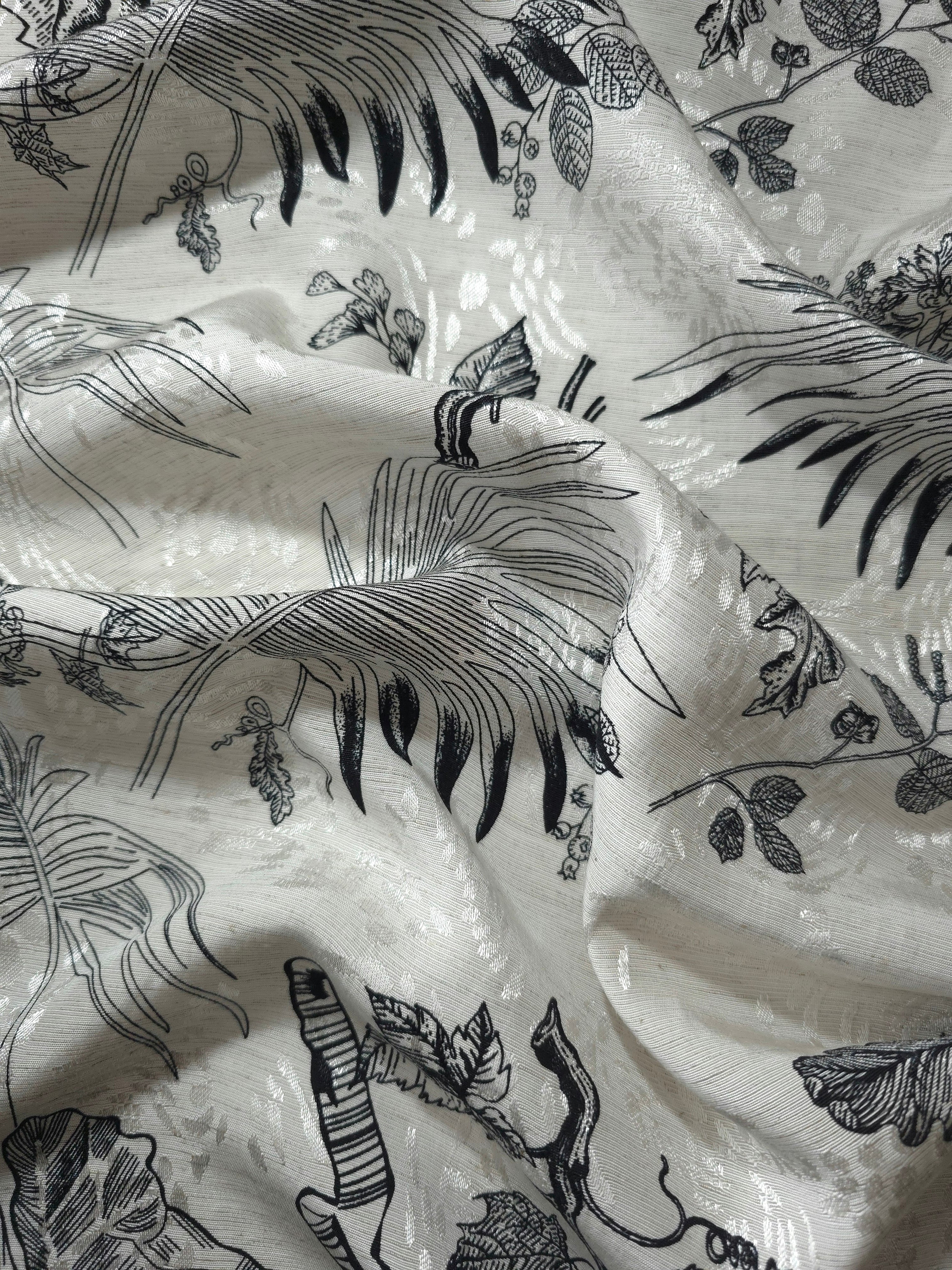 Black palm vine linen-look jacquard fabric draped to show soft structure and tonal botanical design.