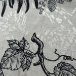 Black palm vine linen-look jacquard fabric pattern overview with tonal leaf and vine motif.