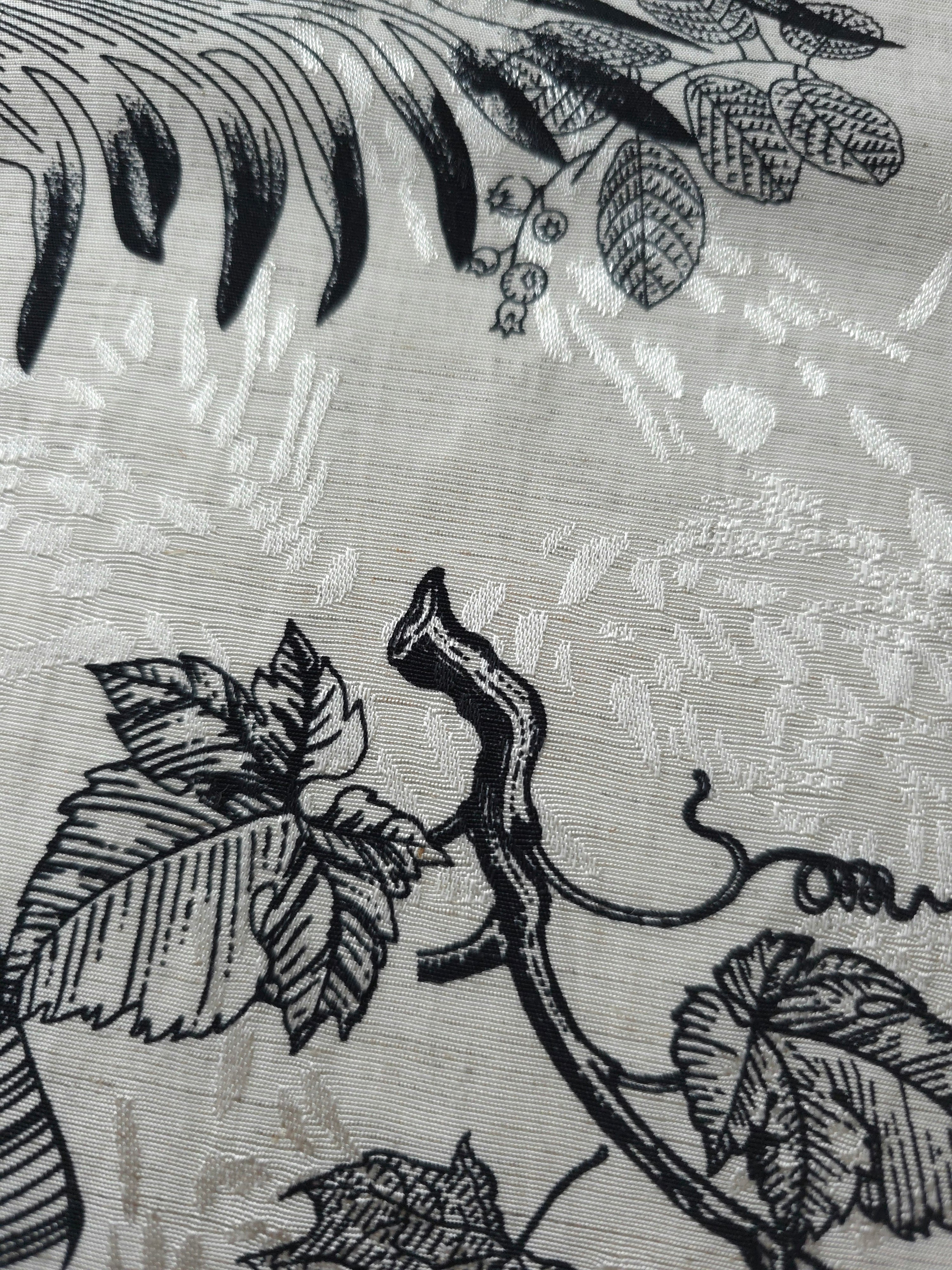 Black palm vine linen-look jacquard fabric pattern overview with tonal leaf and vine motif.