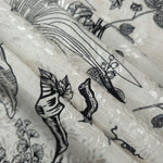 Reverse side of black palm vine jacquard fabric showing woven structure and linen-like surface.