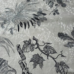 Texture view of black palm vine linen-look jacquard fabric with subtle woven botanical pattern.