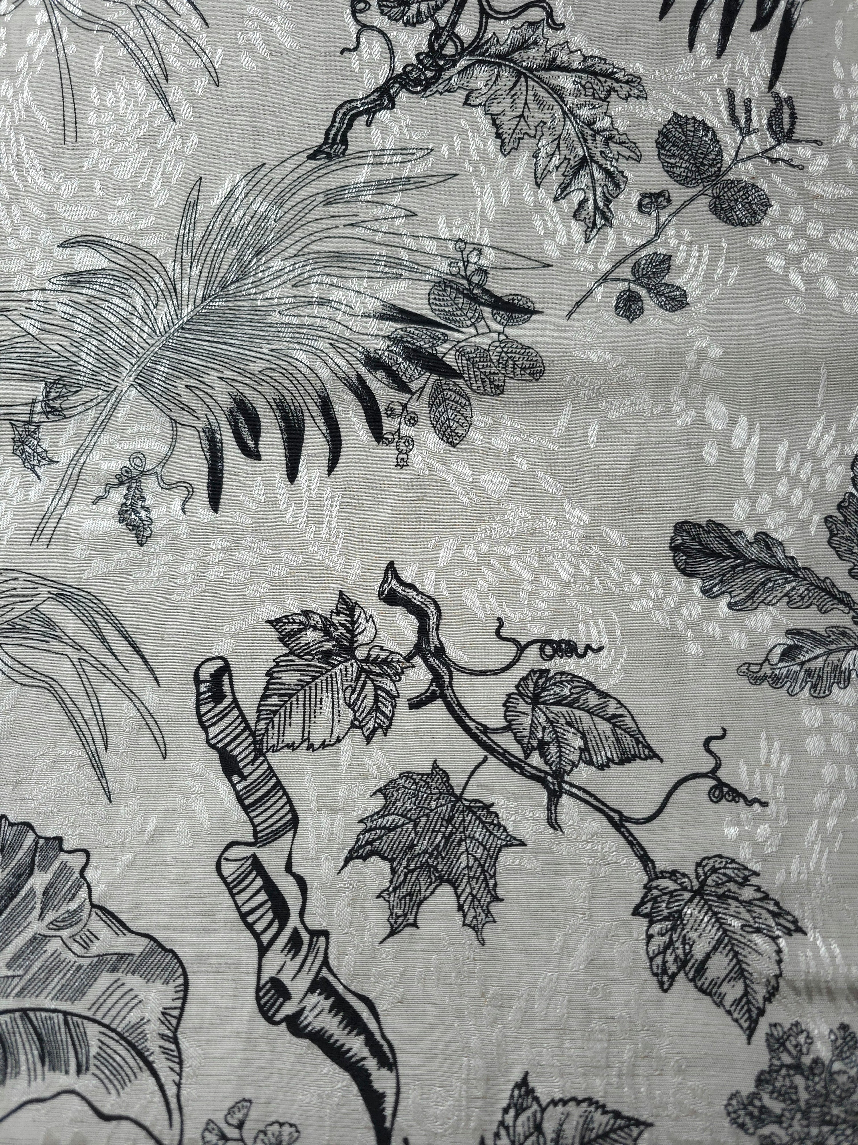 Texture view of black palm vine linen-look jacquard fabric with subtle woven botanical pattern.
