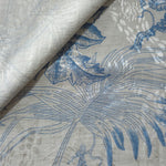Blue palm vine jacquard fabric close-up detail with linen-look texture and tonal leaf motif.