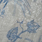 Blue palm vine linen-look jacquard fabric pattern overview with tonal leaf and vine design.