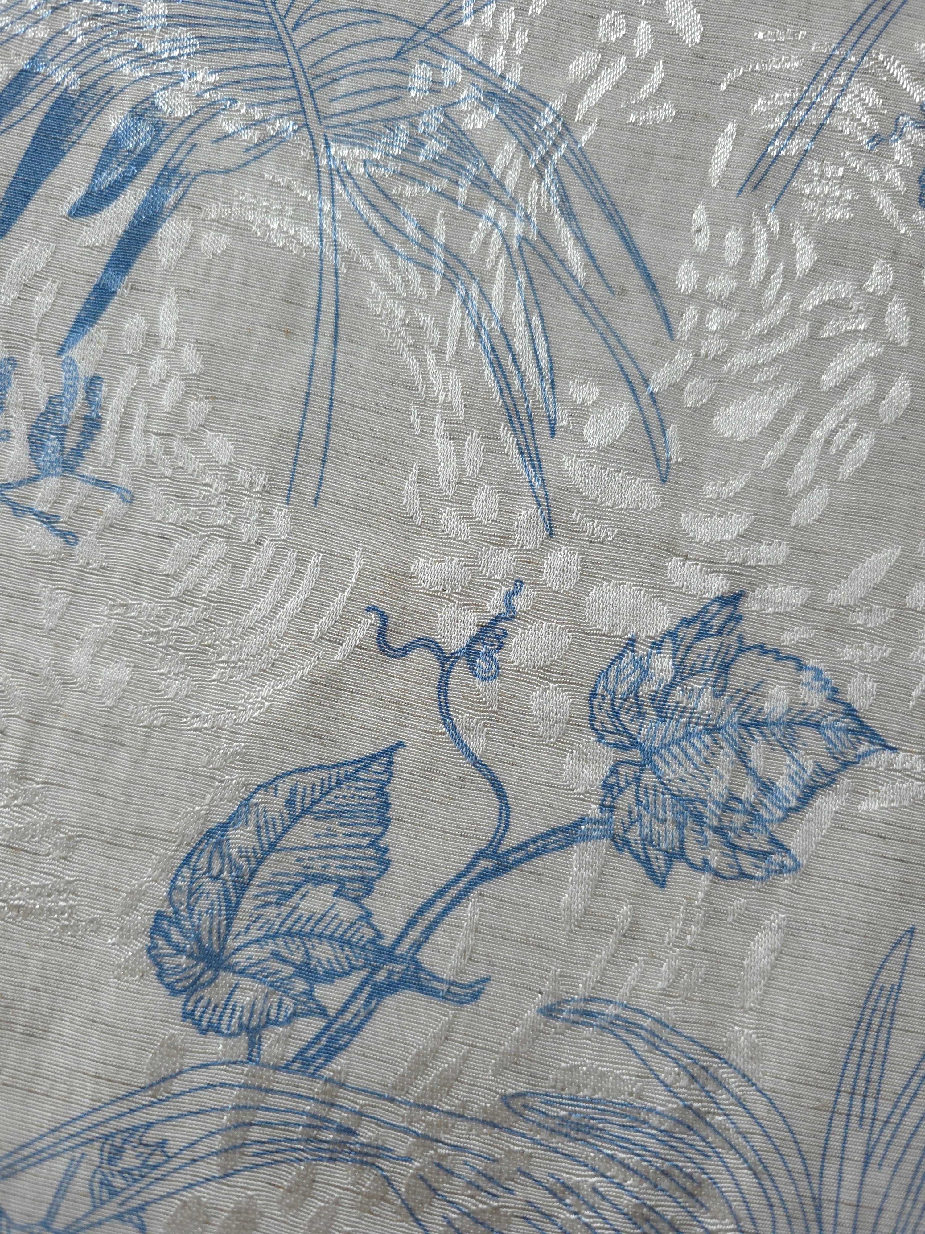 Blue palm vine linen-look jacquard fabric pattern overview with tonal leaf and vine design.