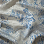 Reverse side of blue palm vine jacquard fabric showing woven construction and linen-like hand.