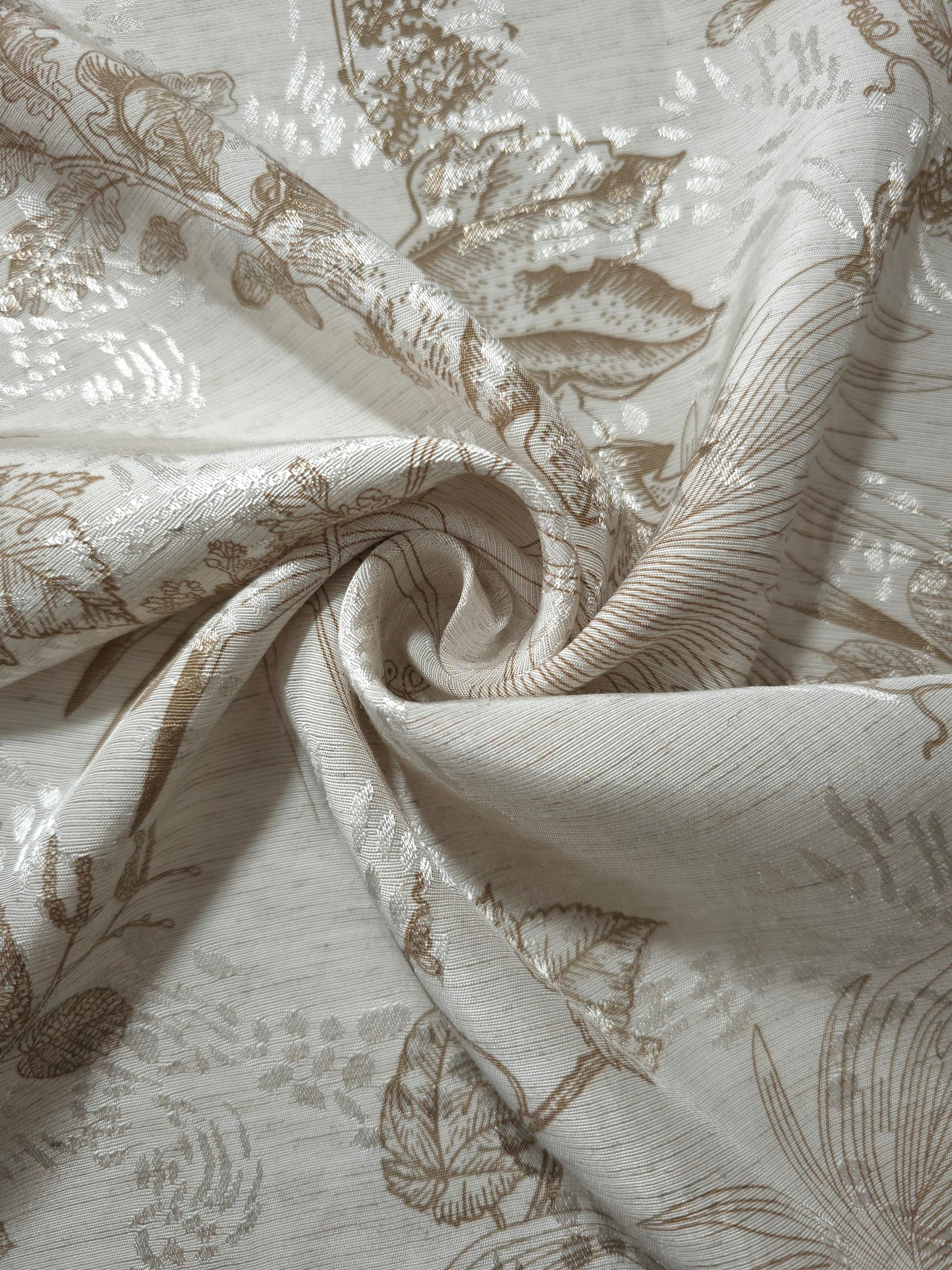 Brown palm vine linen-look jacquard fabric folded view showing apparel drape and woven leaf design.