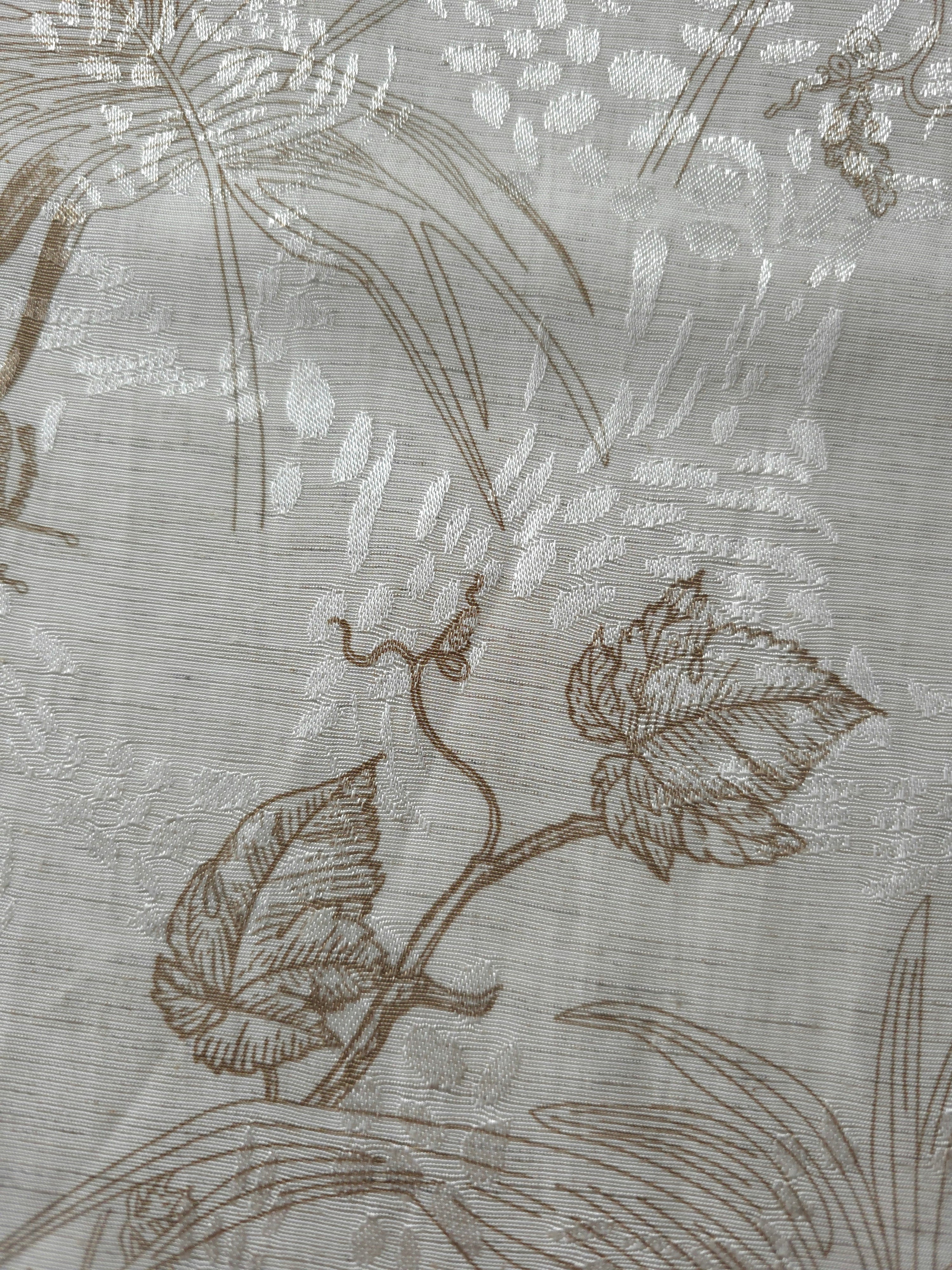 Texture view of brown palm vine linen-look jacquard fabric with woven leaf and vine pattern.