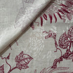 Deep red palm vine jacquard fabric close-up with woven leaf motif and linen-look texture.