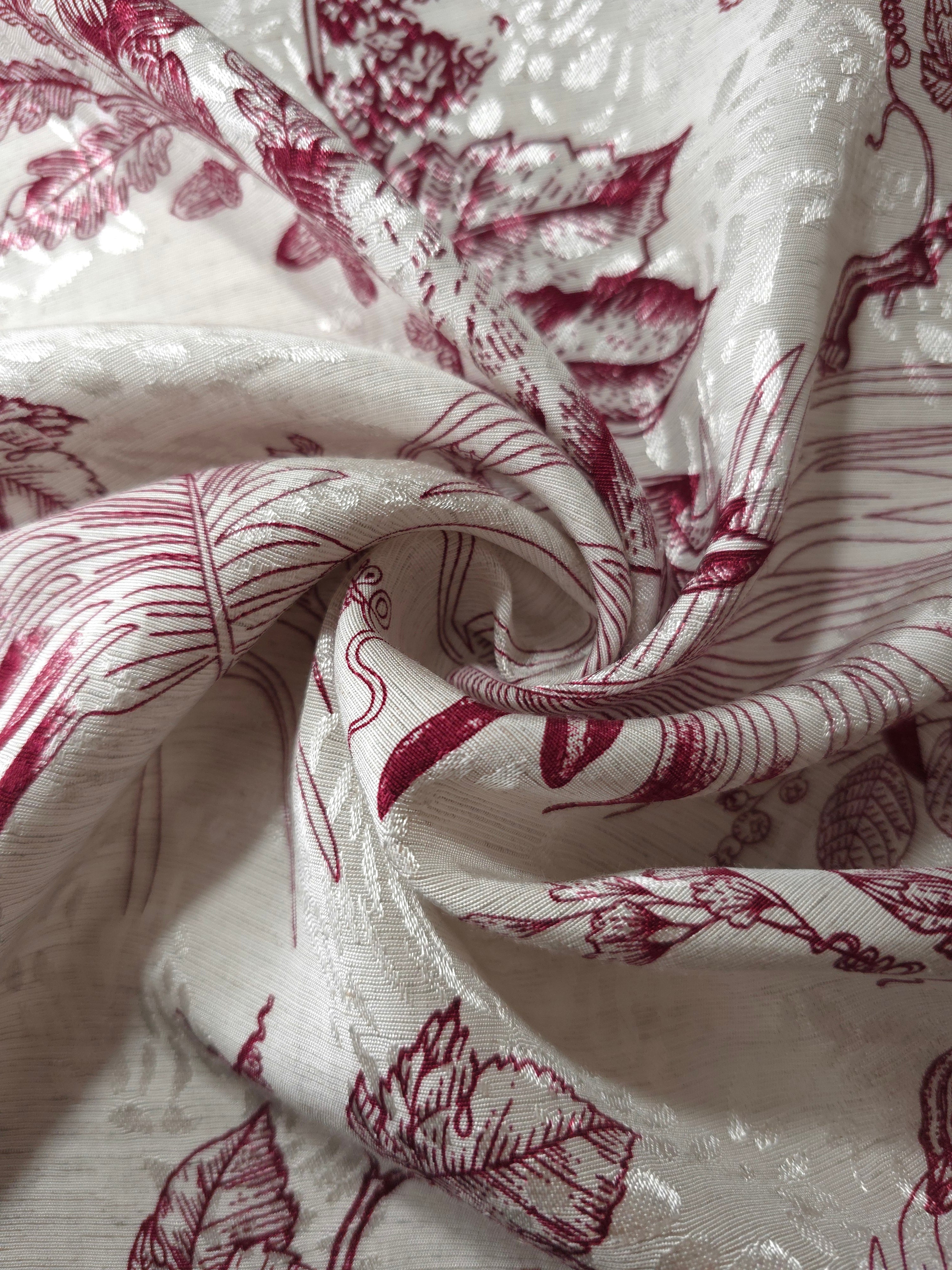 Deep red palm vine linen-look jacquard fabric folded view showing apparel drape and texture.