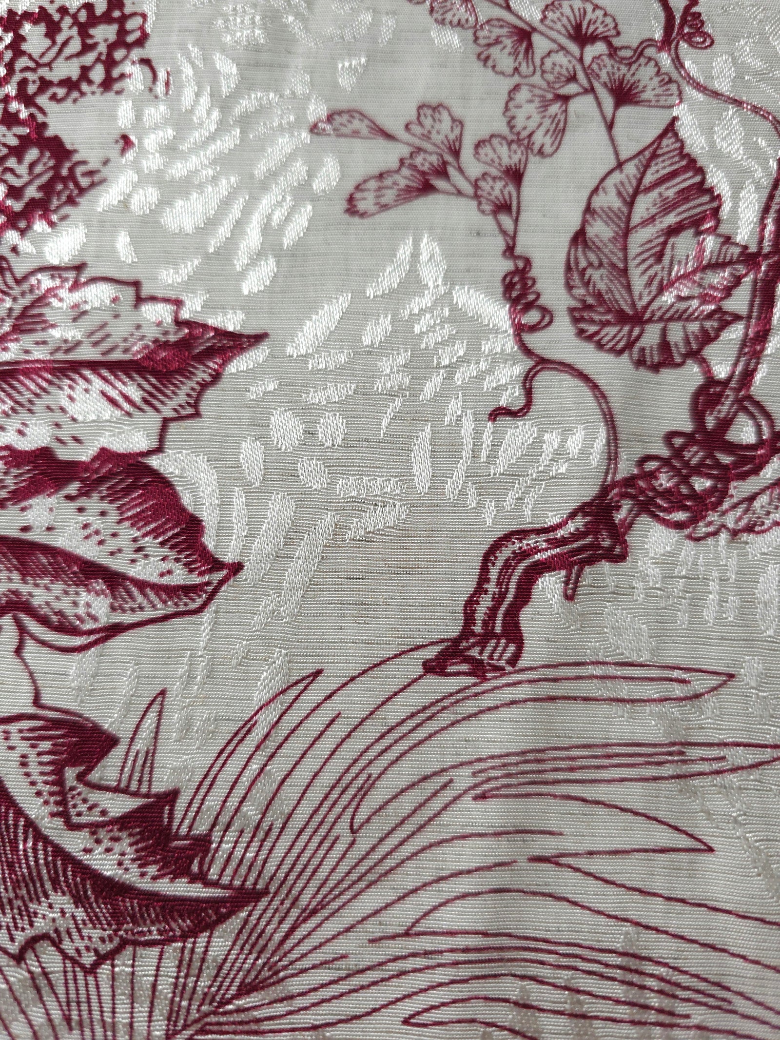 Deep red palm vine linen-look jacquard fabric pattern overview with tonal botanical design.