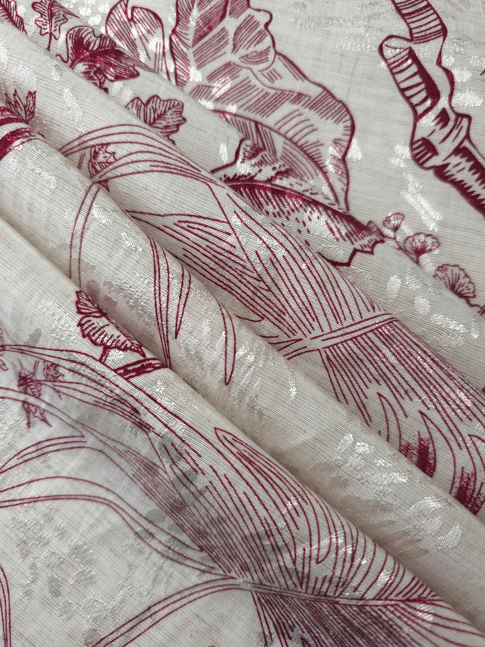 Reverse side of deep red palm vine jacquard fabric showing woven structure and textured finish.