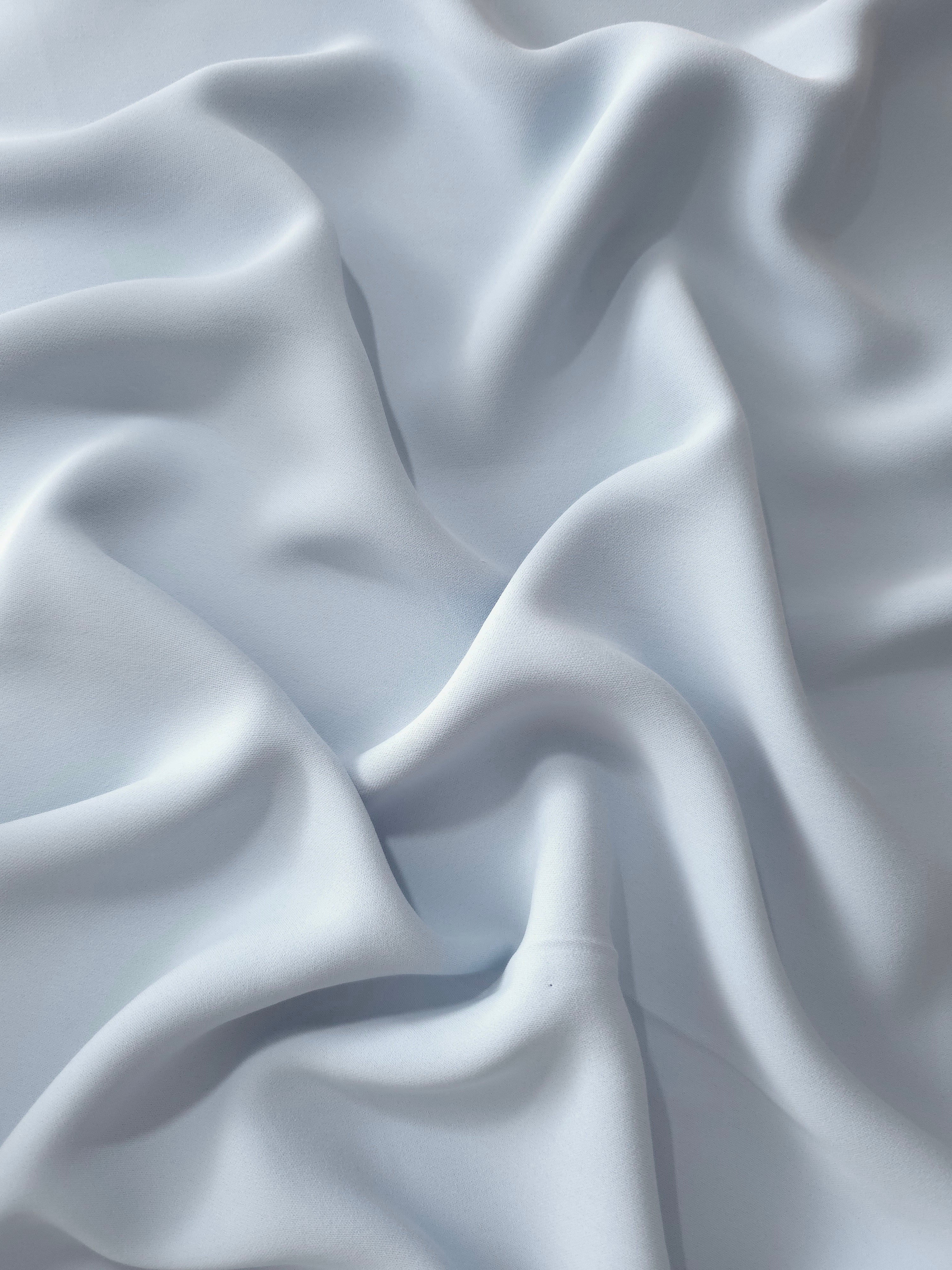 Pearl Blue Gray polyester crepe in draped folds for dresses, skirts, blouses and elegant apparel