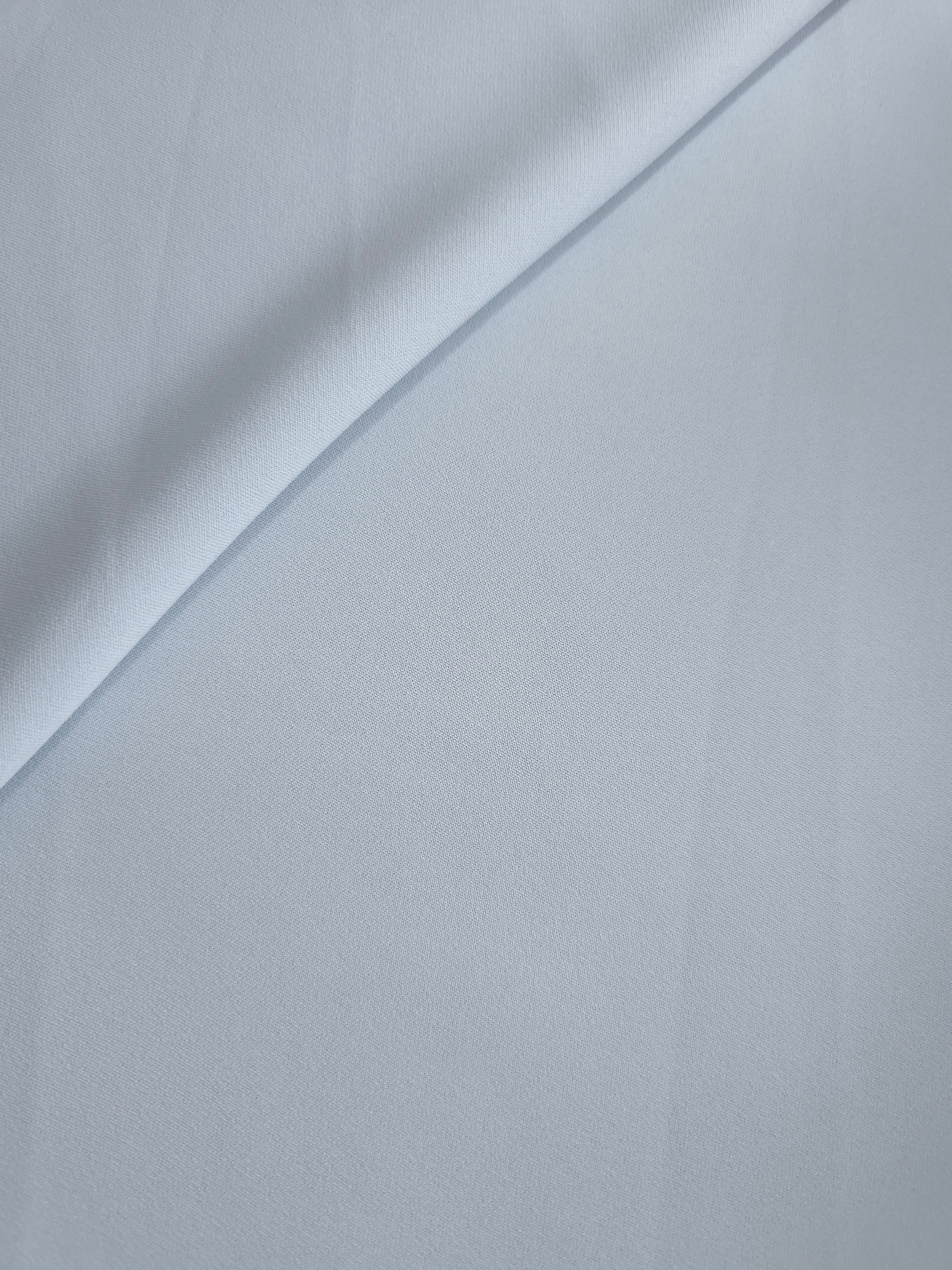 Pearl Blue Gray polyester crepe in a soft fold, showing fluid drape for dresses and blouse making