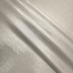 Layered folds of Pearl Ivory foiled stretch fabric showing shimmer, body and movement for performance outfits and statement garments