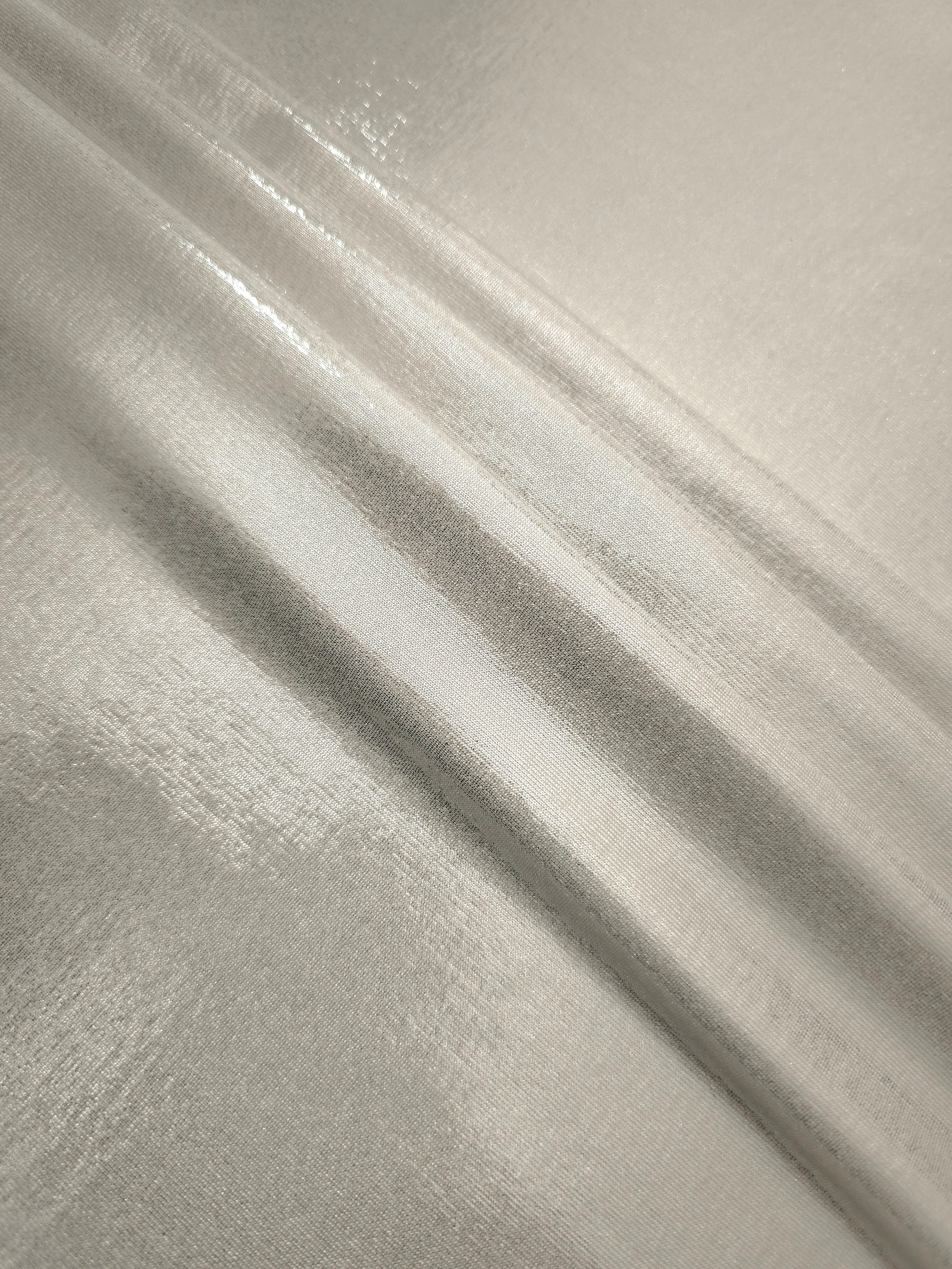 Layered folds of Pearl Ivory foiled stretch fabric showing shimmer, body and movement for performance outfits and statement garments