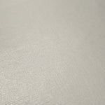 Detailed close-up of Pearl Ivory foiled spandex fabric showing its luminous metallic surface and fine reflective texture
