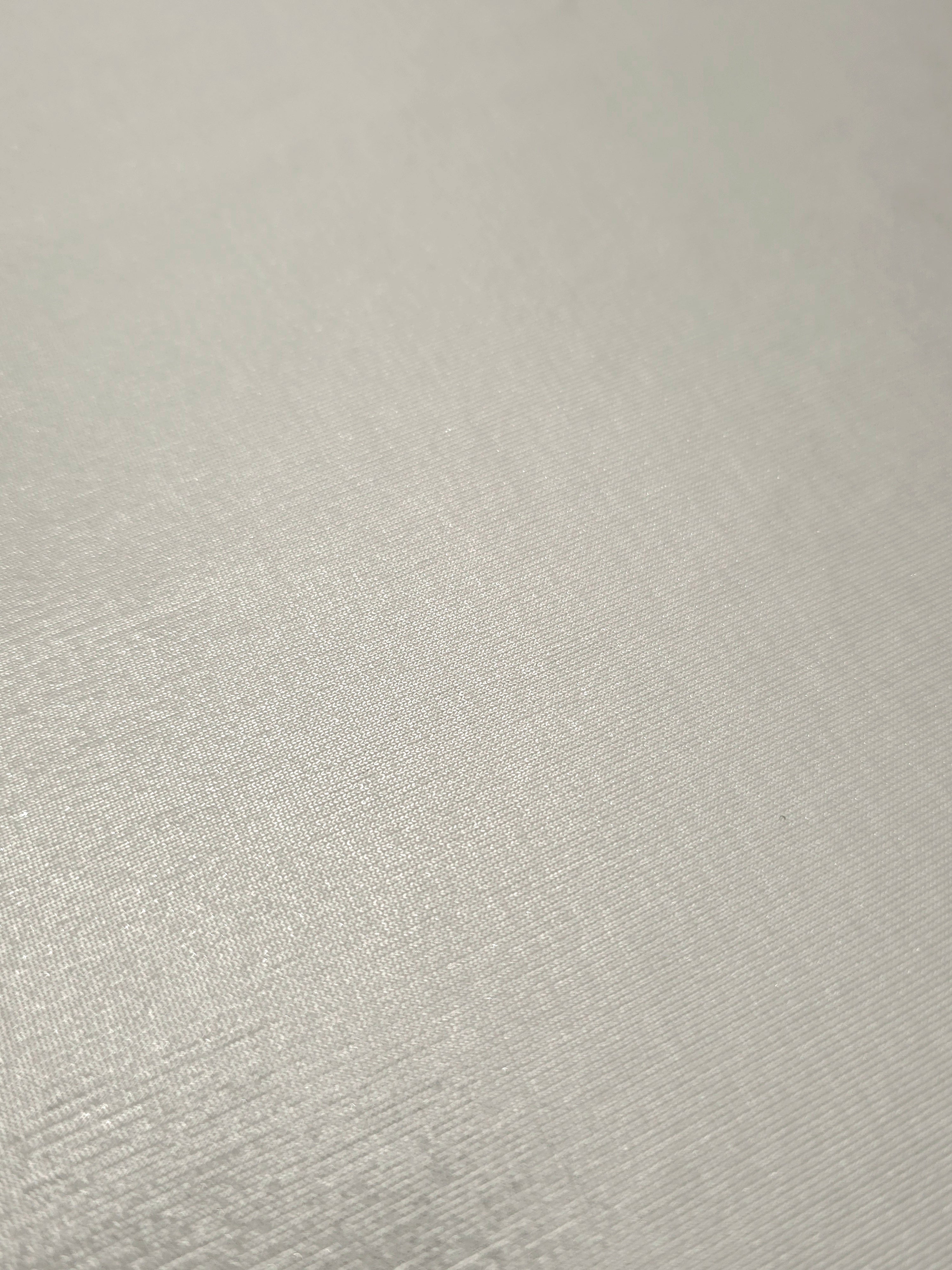 Detailed close-up of Pearl Ivory foiled spandex fabric showing its luminous metallic surface and fine reflective texture