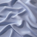 Draped folds of Periwinkle Blue polyester crepe showing opaque coverage and fluid movement for garment making