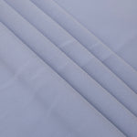 Layered Periwinkle Blue Korean polyester crepe showing gentle mechanical stretch and soft structure for dressmaking