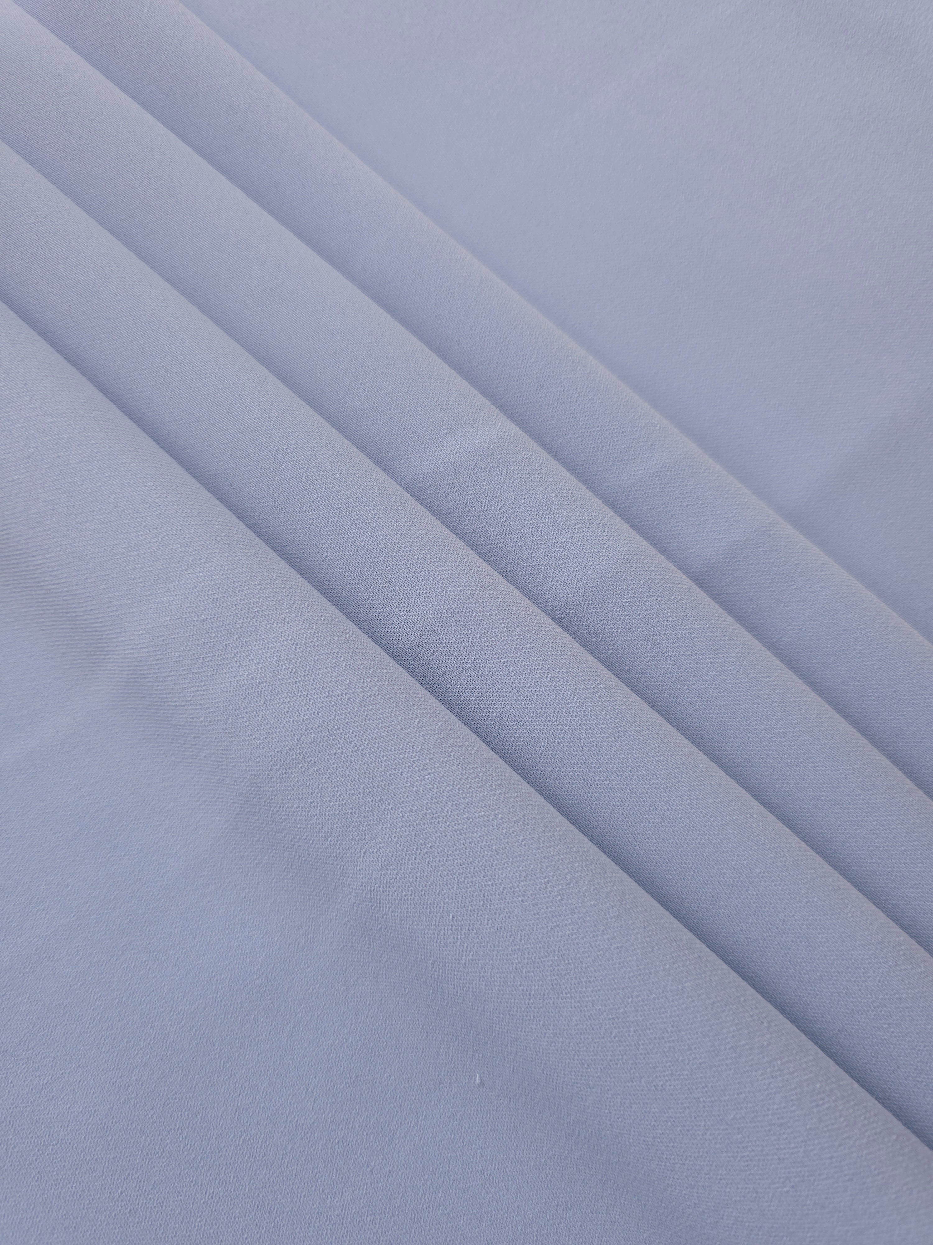 Layered Periwinkle Blue Korean polyester crepe showing gentle mechanical stretch and soft structure for dressmaking
