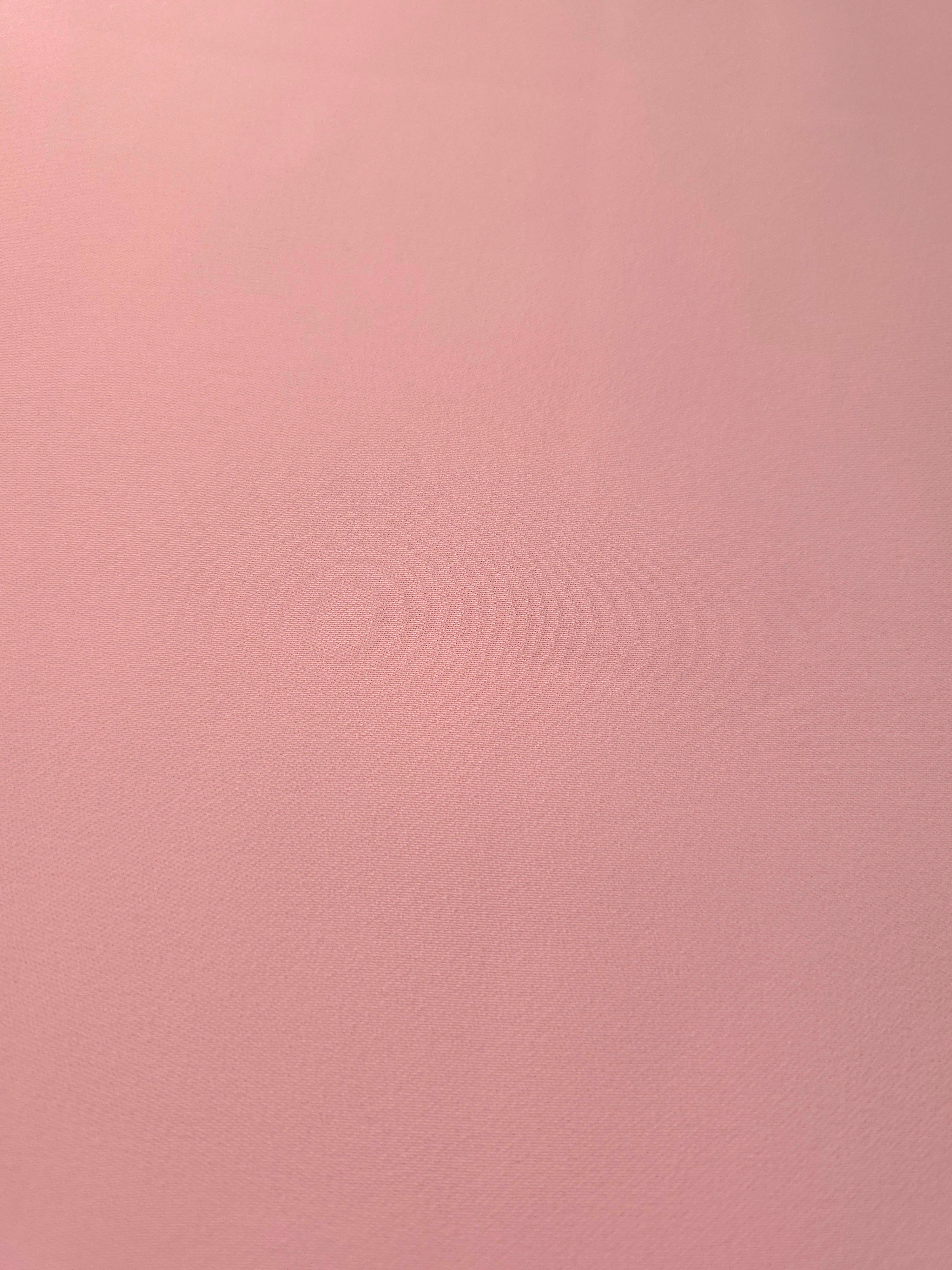 Fine texture close-up of Powder Rose Pink mechanical polyester crepe showing a smooth, silky-soft woven hand