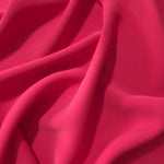 Raspberry Red Korean polyester dress fabric shown in draped folds for occasionwear, blouses and dresses