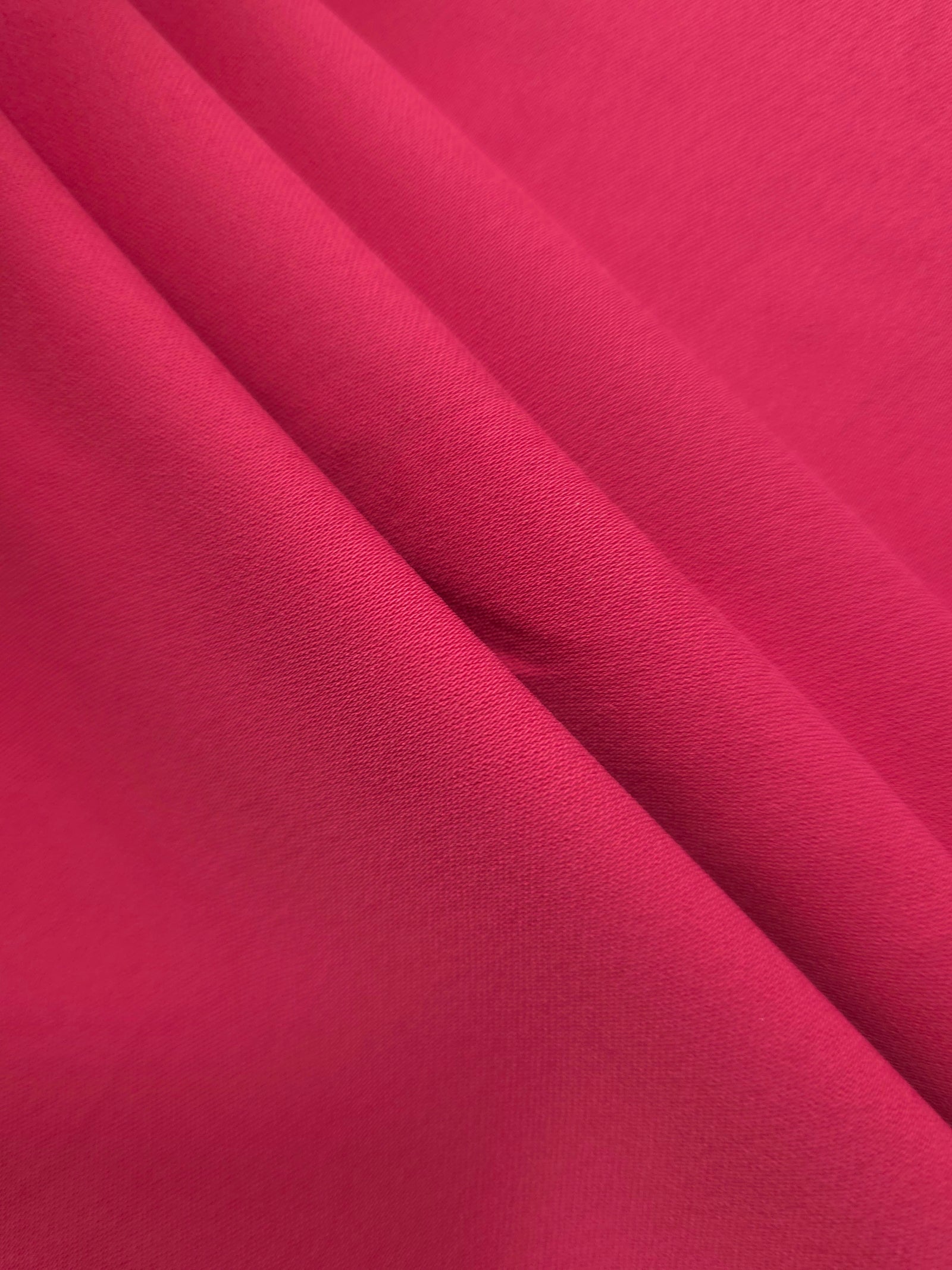 Raspberry Red mechanical polyester crepe layered to show soft structure for tailored garments and separates