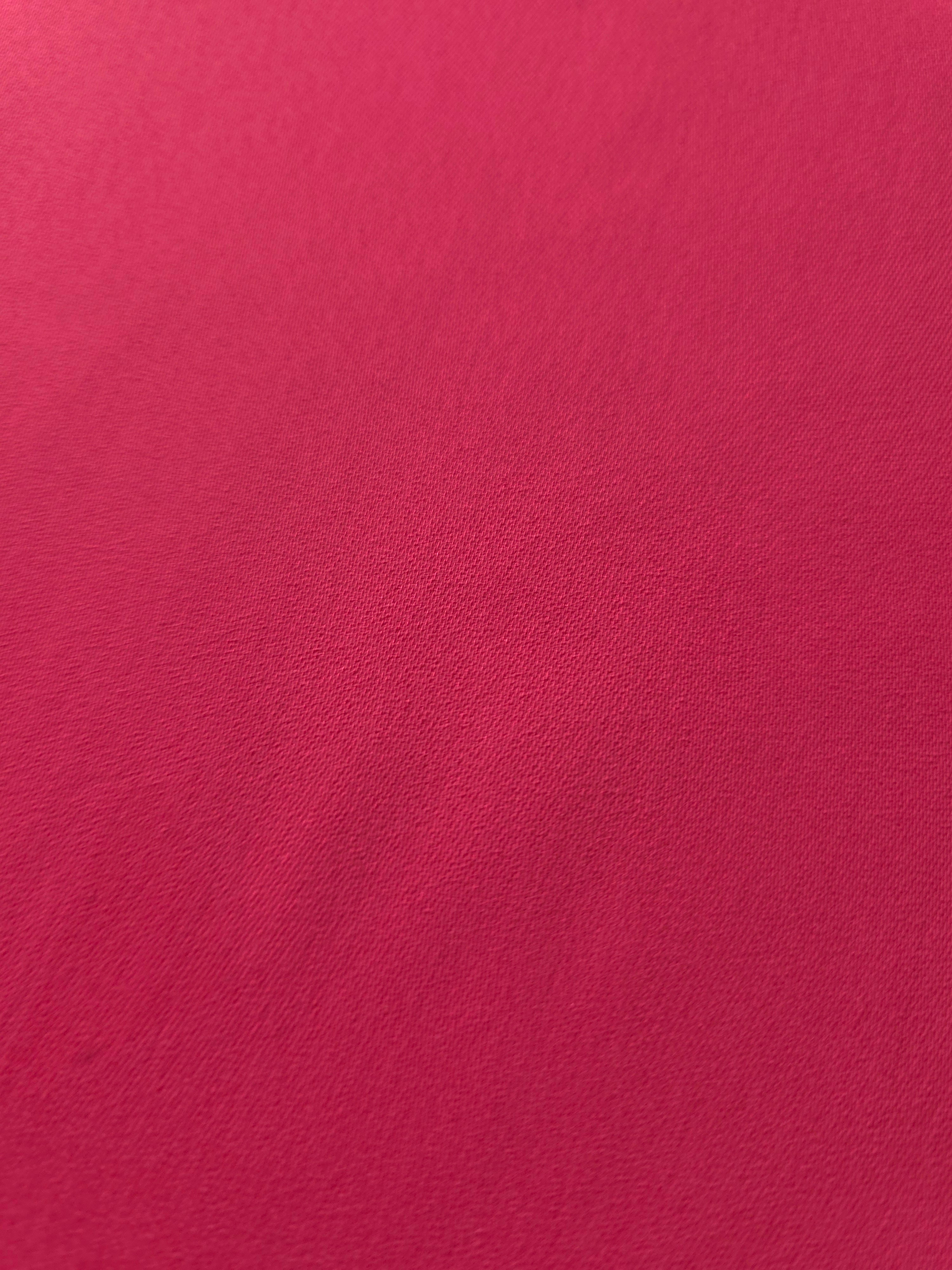 Close woven detail of Raspberry Red 100% polyester Korean crepe showing its smooth texture and soft finish