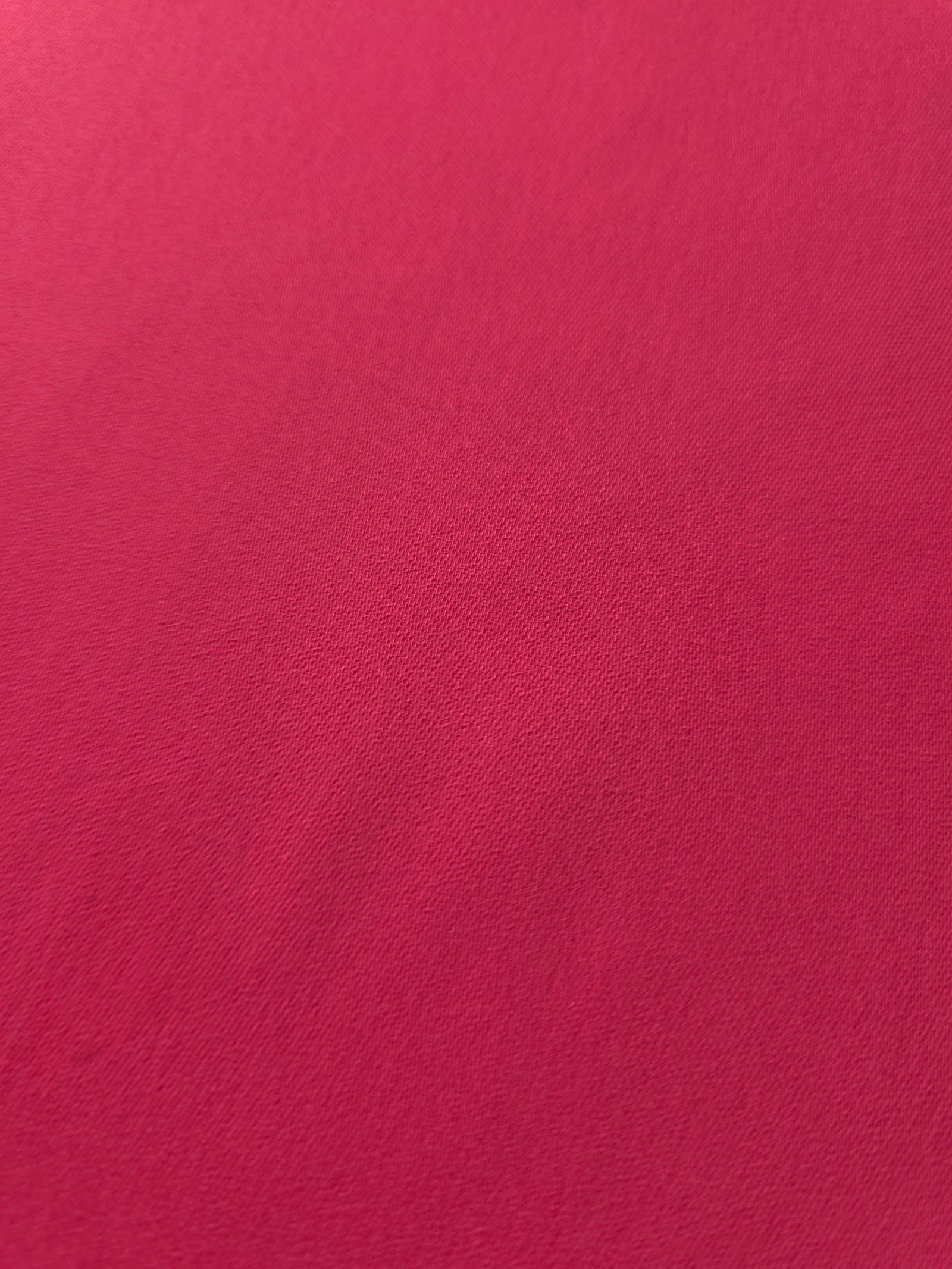 Close woven detail of Raspberry Red 100% polyester Korean crepe showing its smooth texture and soft finish