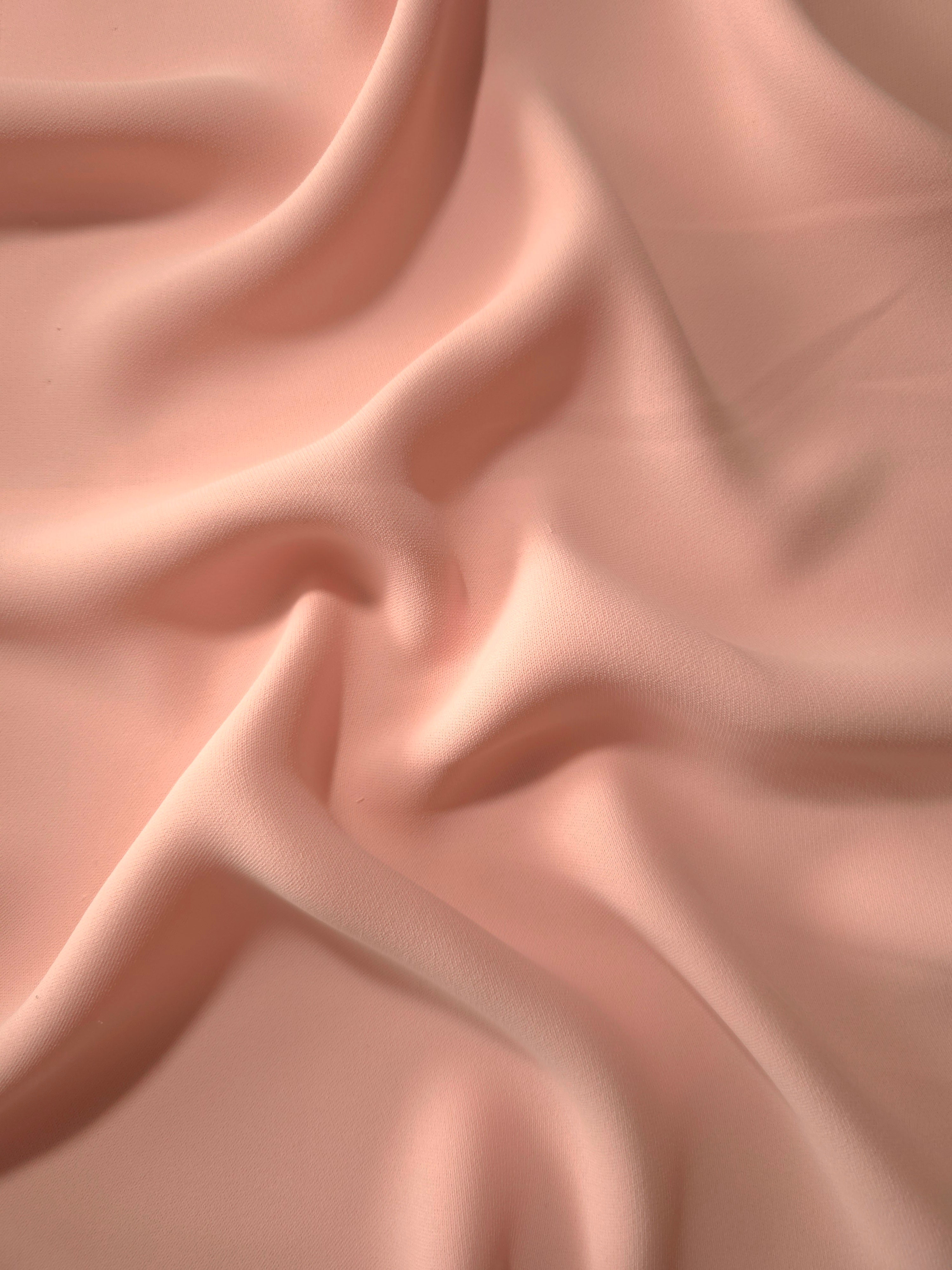 Rose Beige Korean crepe displayed in fluid draped folds for eveningwear, skirts and flowing garments